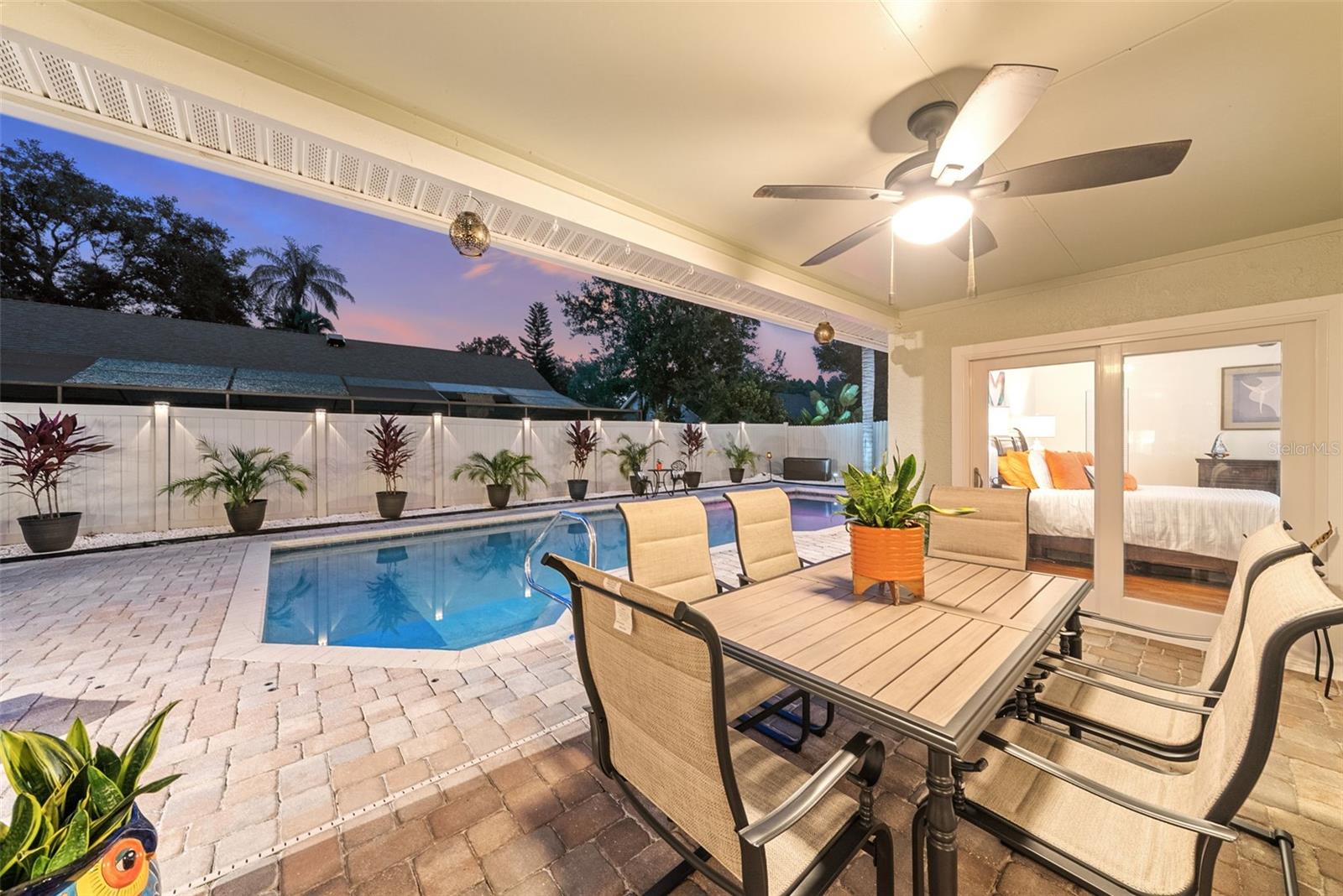 Sunset back exterior covered lanai, French doors on the east and west side from primary suite and kitchen , Sliders in center from living room