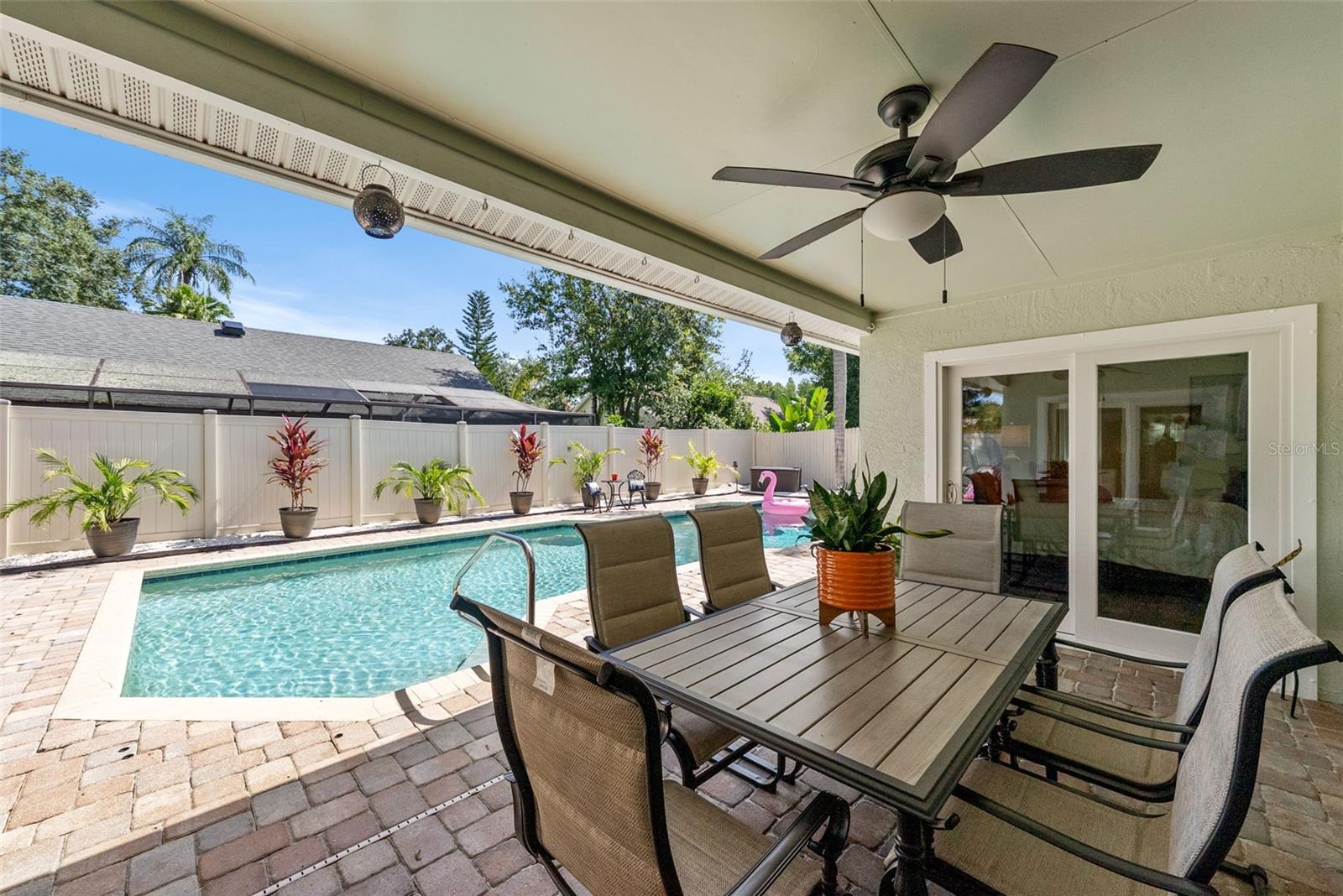 Covered lanai facing west with French doors to primary suite