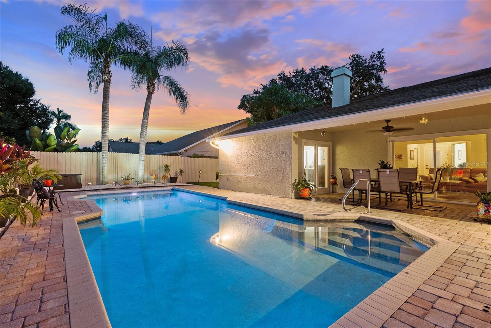 Twilight exterior covered lanai with 3 Everett points to living space , kitchen and primary suite