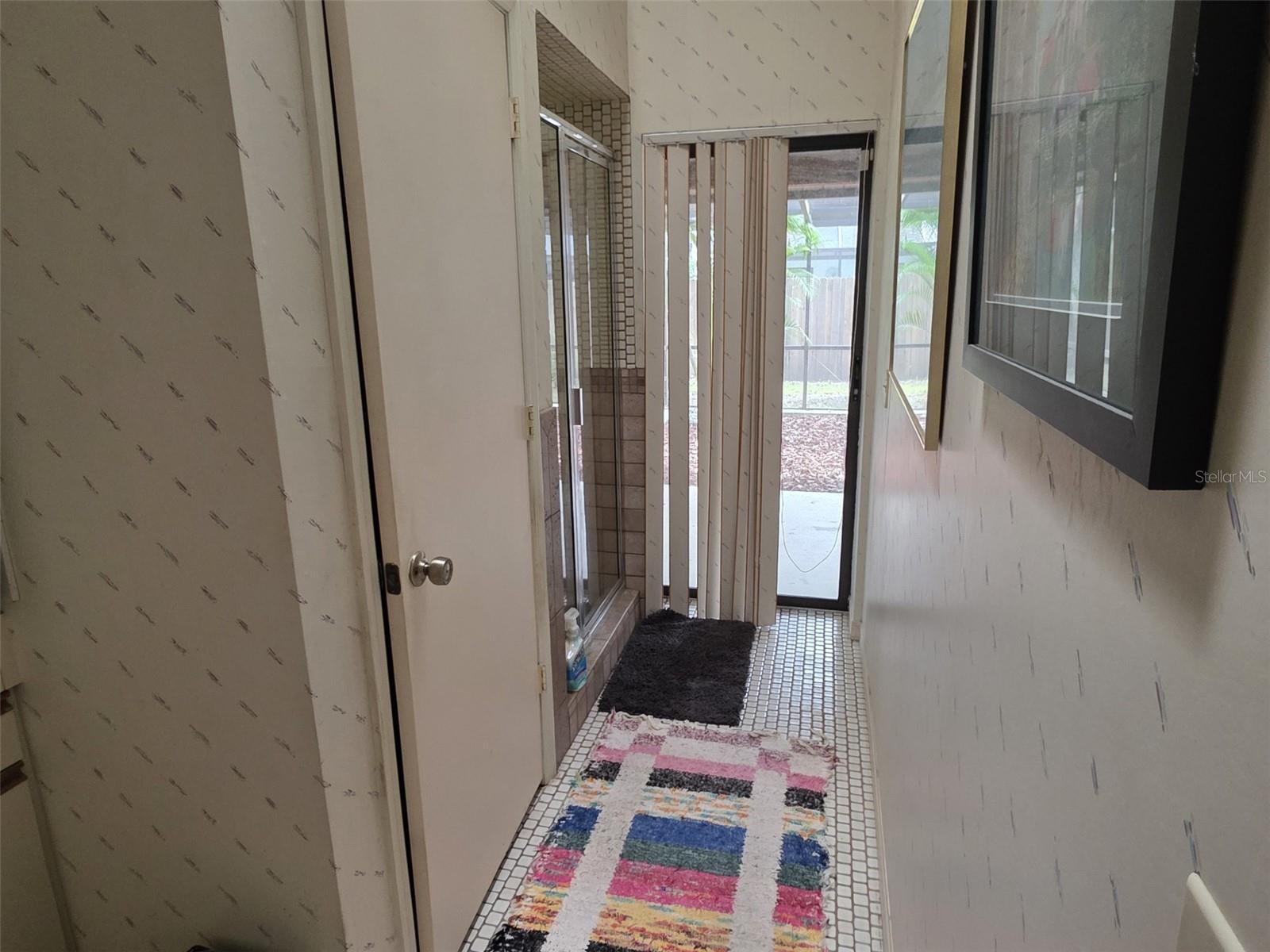 Master bathroom water closet and exit to patio