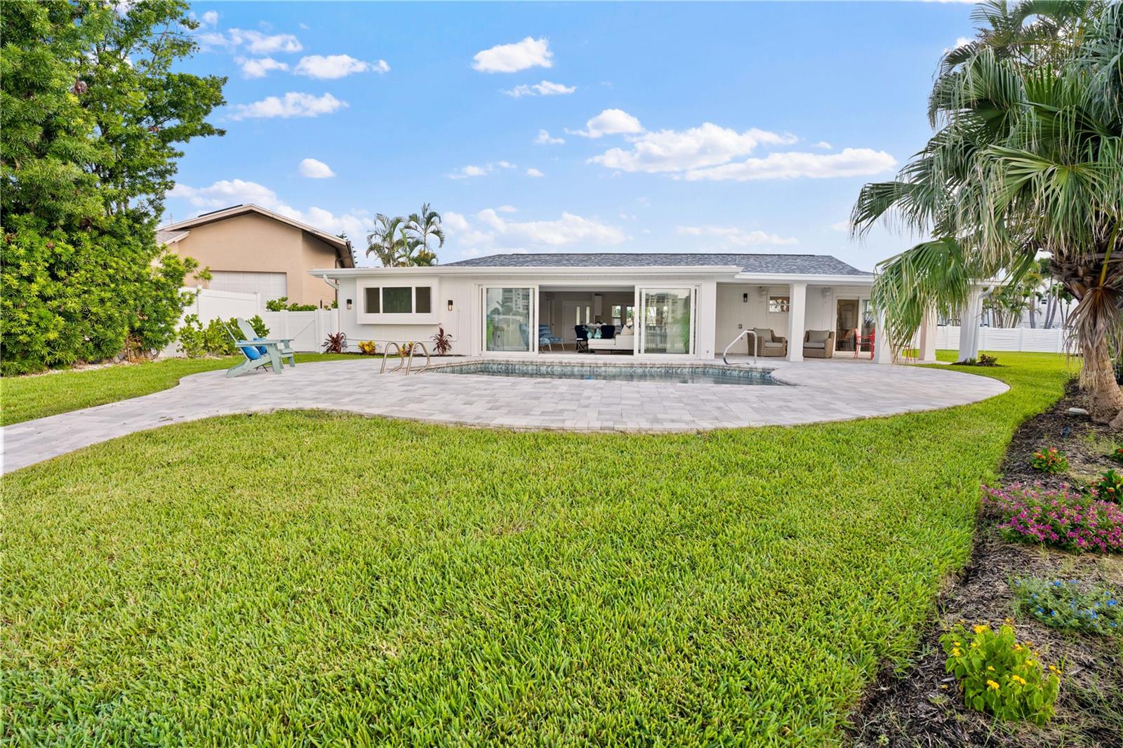 Luxurious and expansive outdoor entertaining space with water views.
