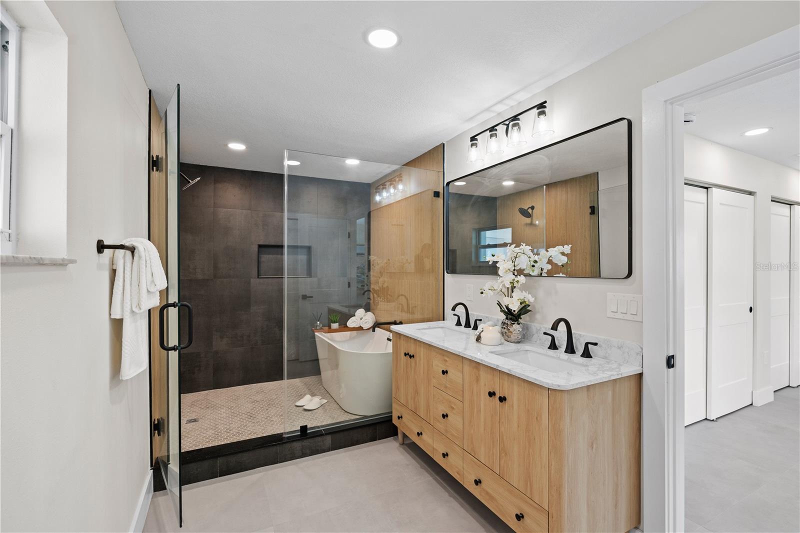 Luxury ensuite bath with soaking tub and dual vanities.