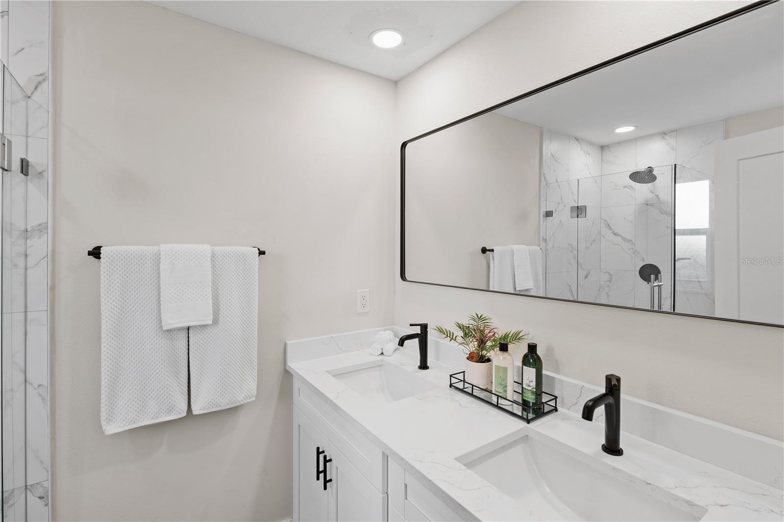 Fully renovated with designer tile and quartz finishes.