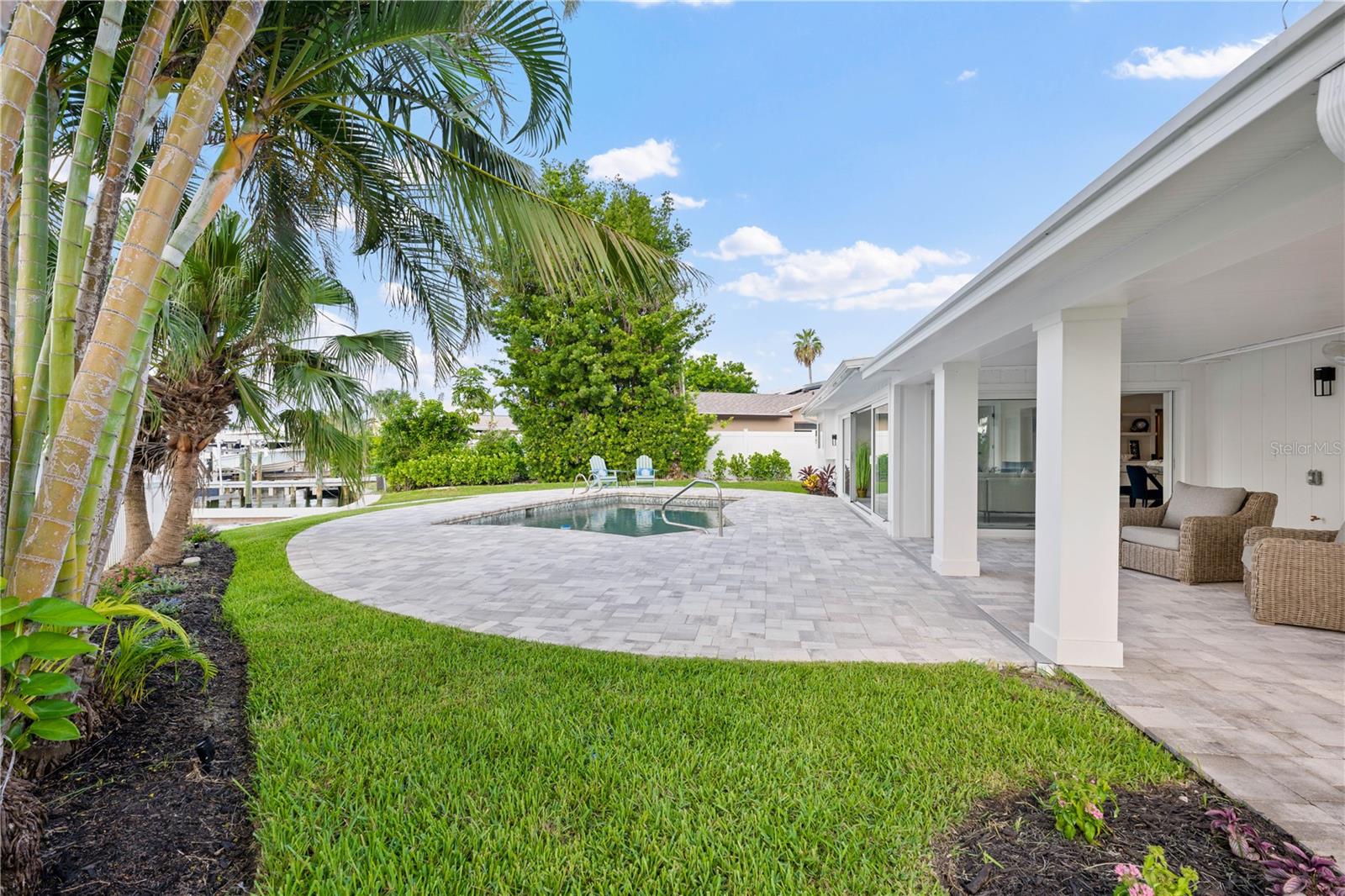 Private backyard oasis with Pebble Tec pool and paver deck