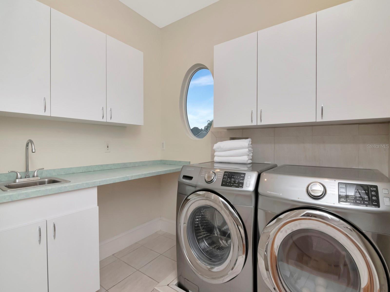 Upstairs Laundry Room with sink and built-in ironing Board.