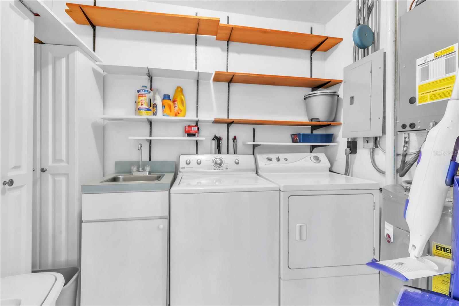 large laundry room and storage area in unit