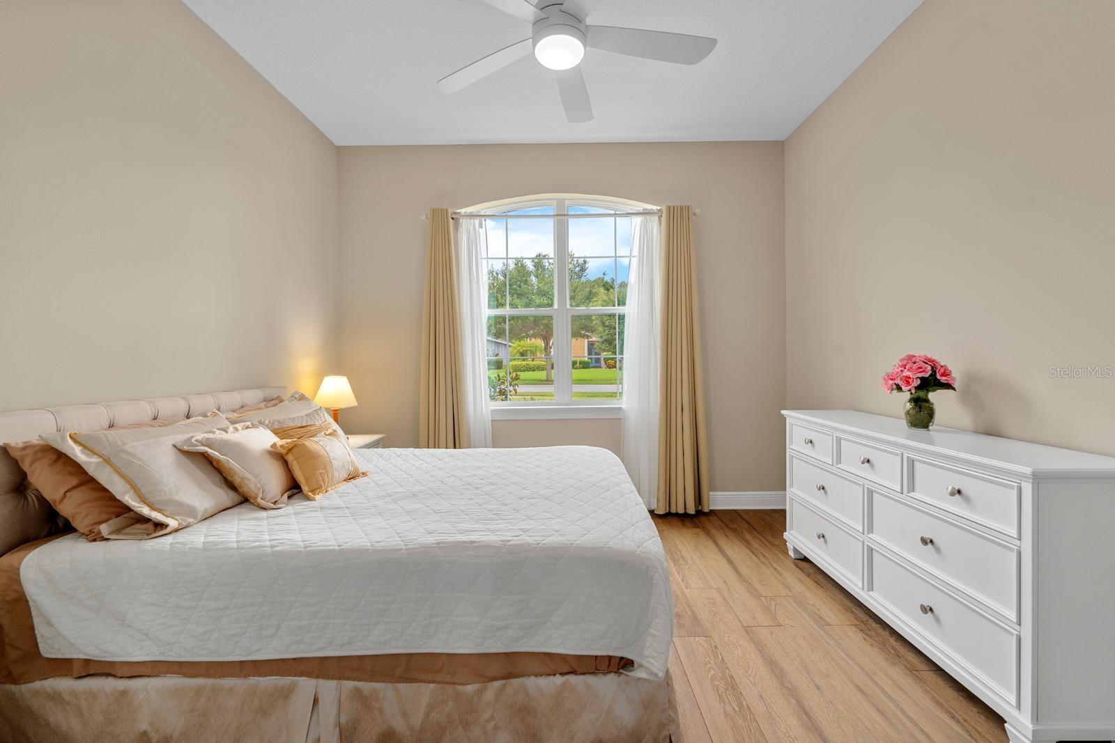 Bedroom 4 with ensuite bathroom features high-end LVP flooring and a walk-in closet.