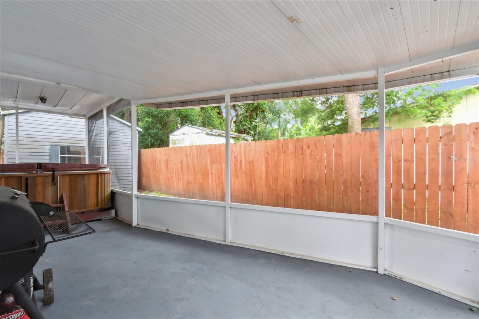 Large, screened side porch with hot tub