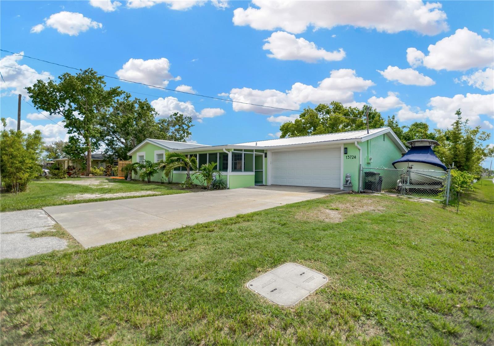 This property offers both side yard space to park your boat or store your RV with electric & plumbing onsite.