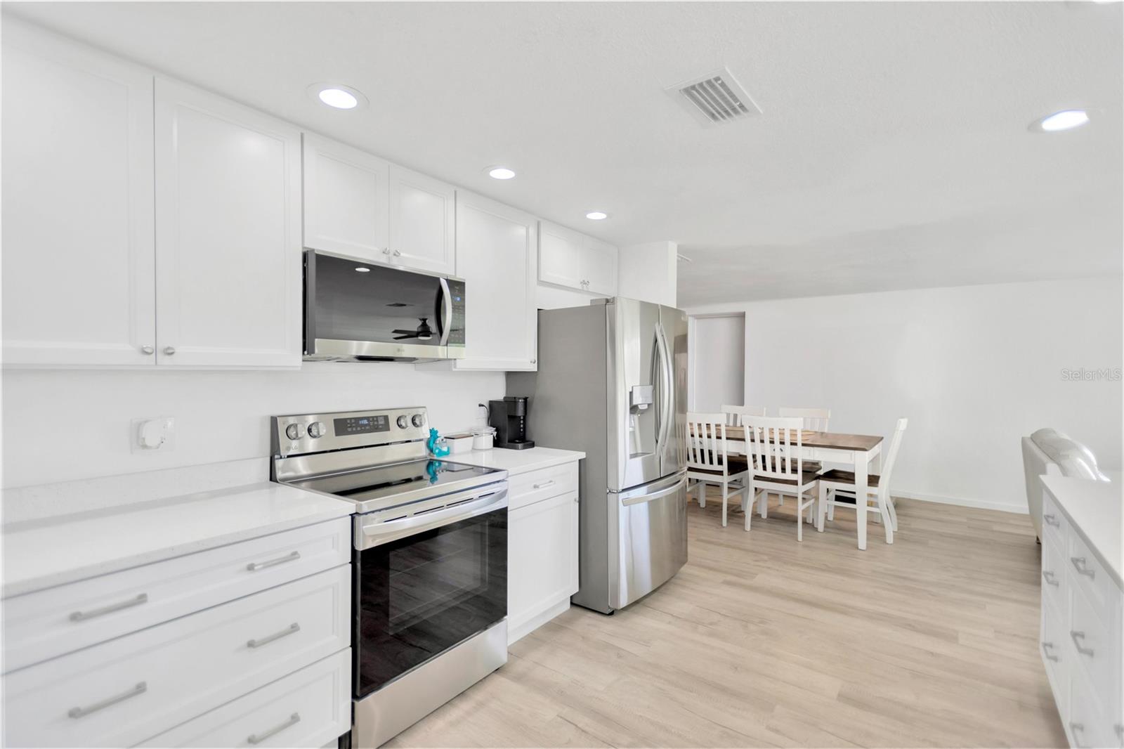 Exquisite rich, white wood cabinetry offers soft close drawers.