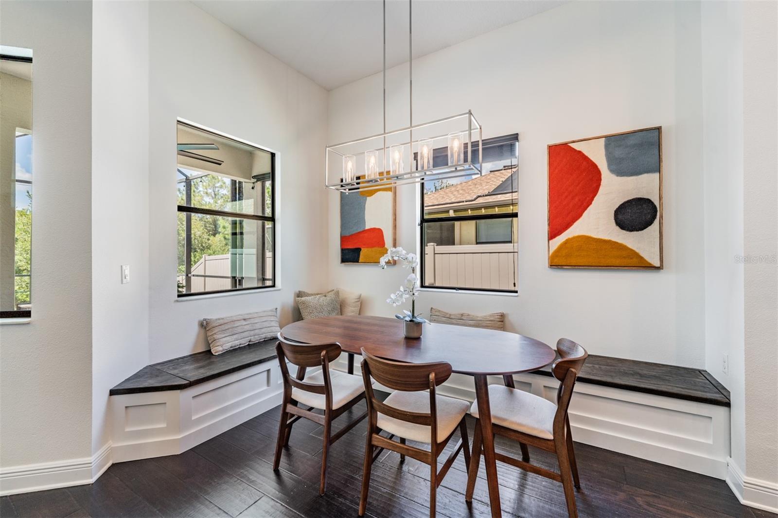 Dining area with custom built-in bench seating with storage is a huge plus