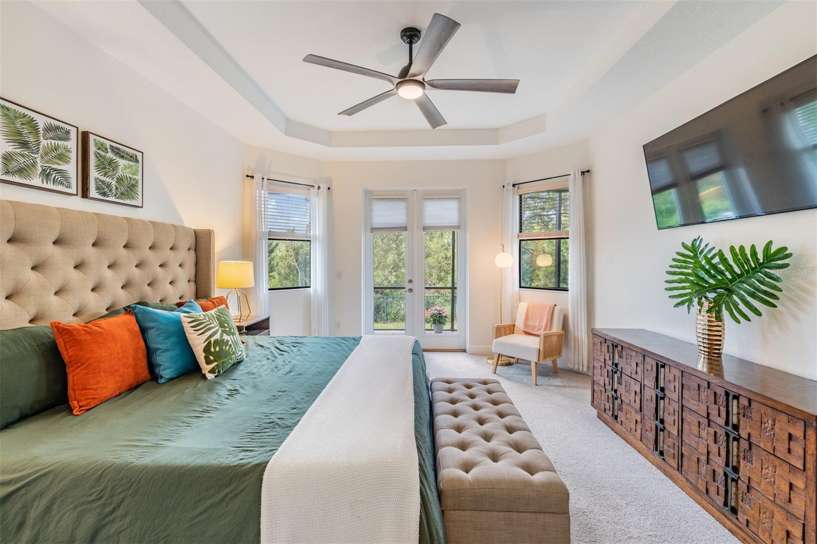 Master on main with a sitting area for a cozy reading nook a French door leading to the exterior