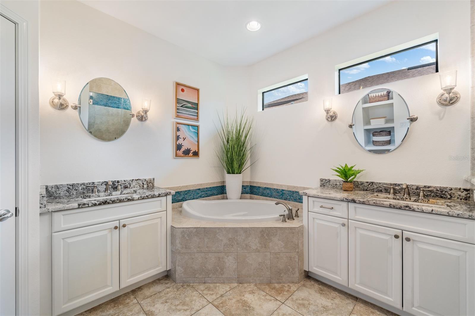 Corner soaking tub, his/her vanities provide additional storage
