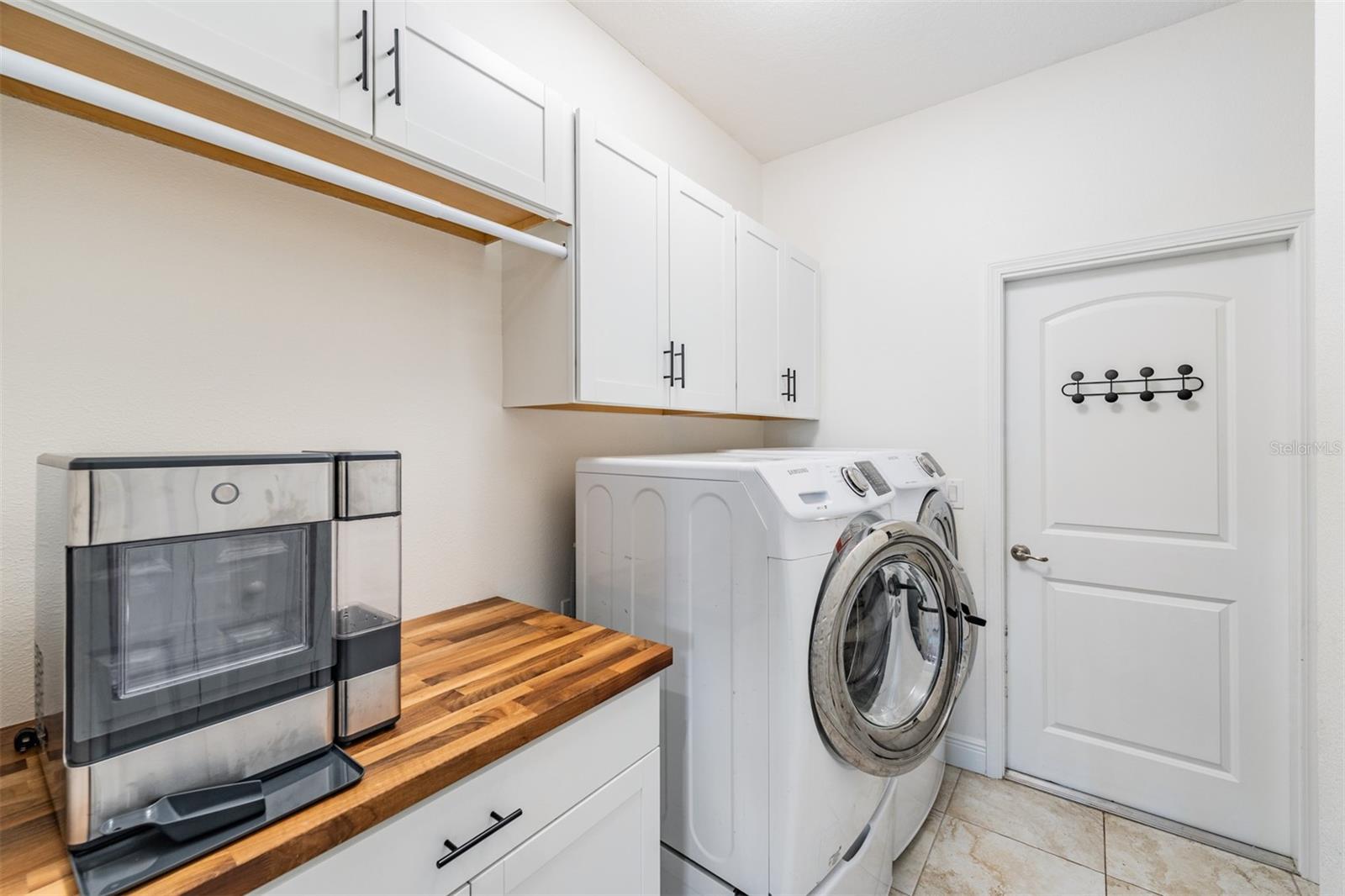 Walk-in laundry room with custom built-ins galore!