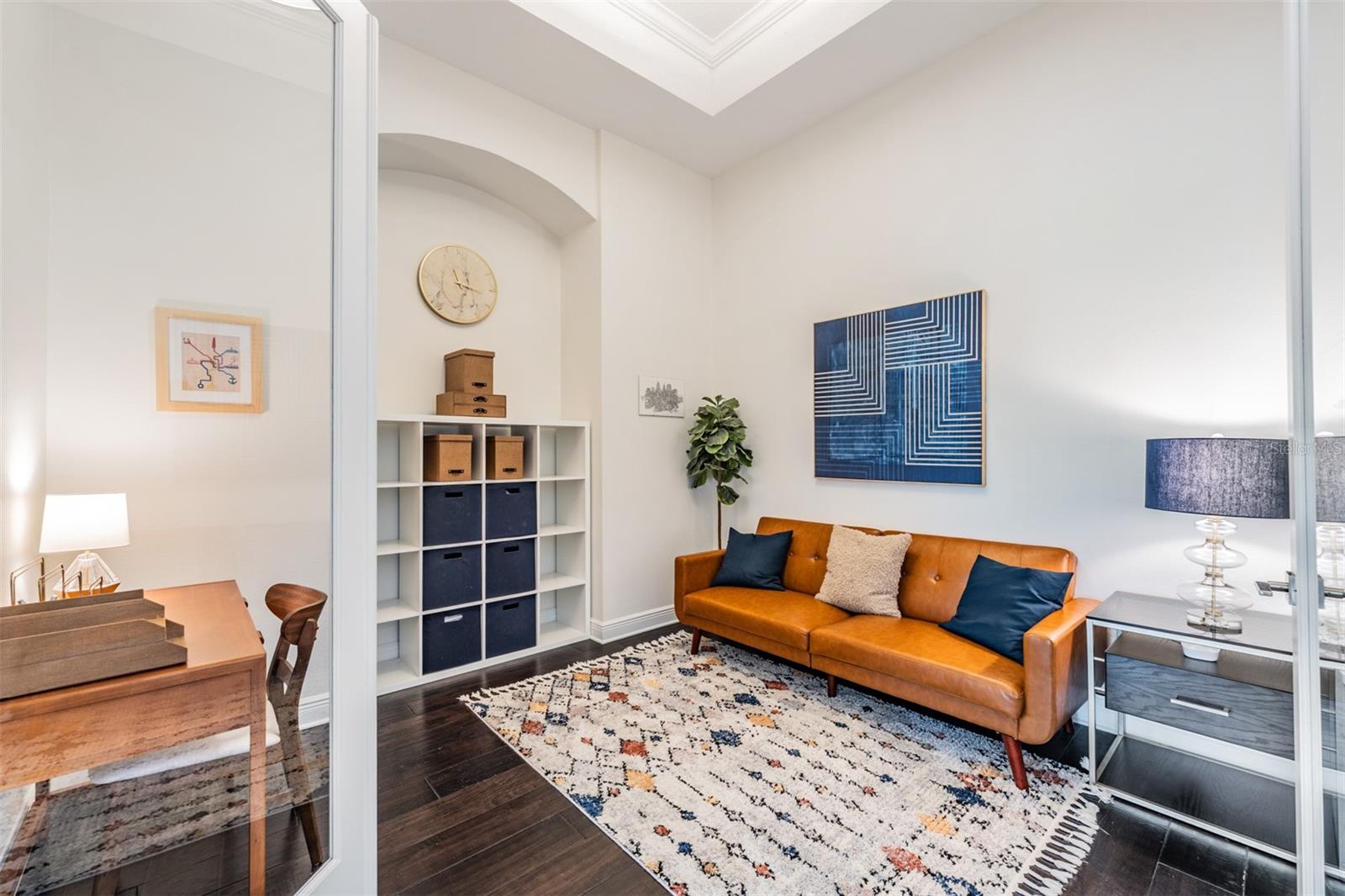 Thoughtful office thru glass doors with custom built-ins