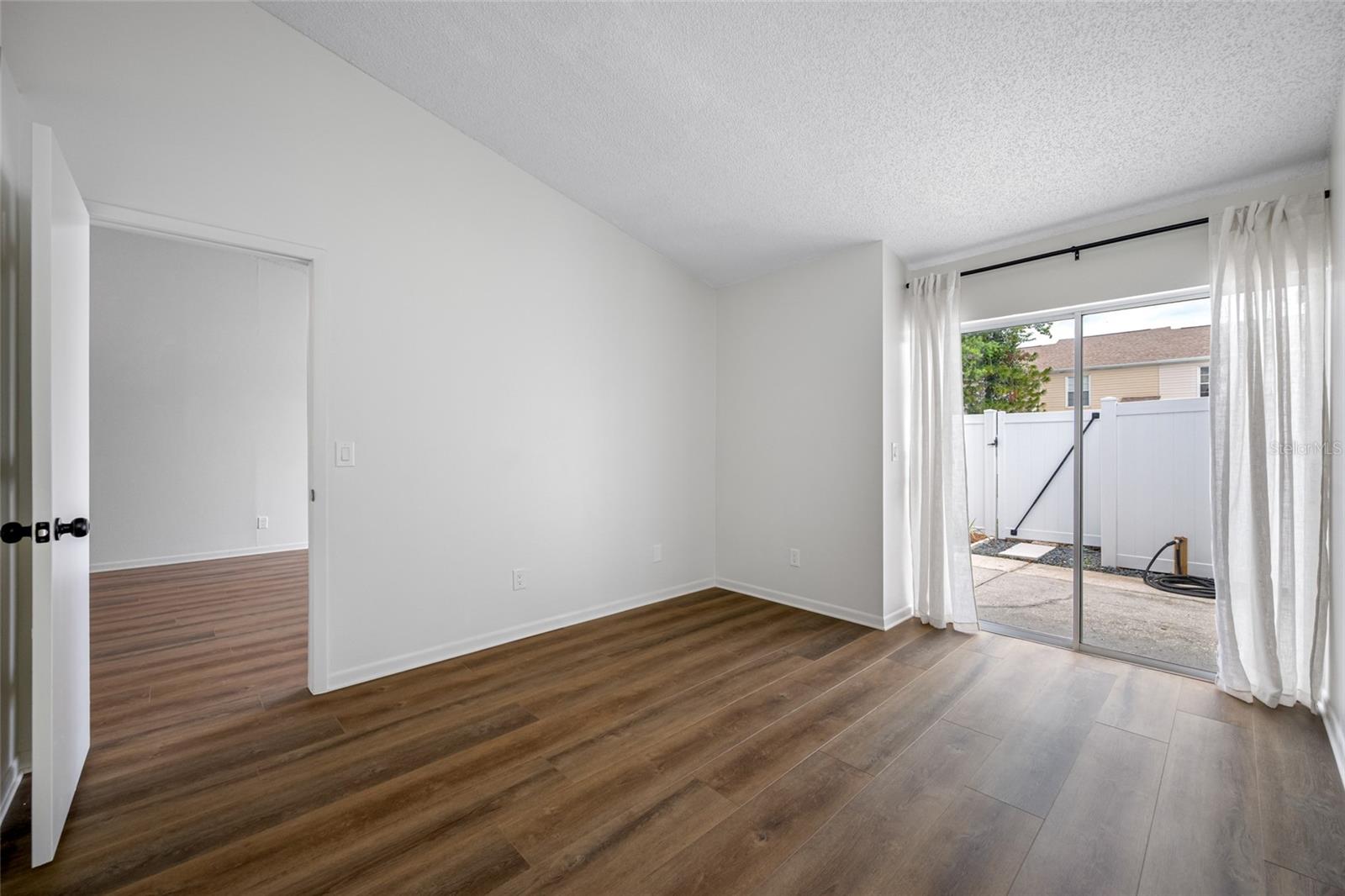 Primary Bedroom offering Opening to Private, Fenced Patio