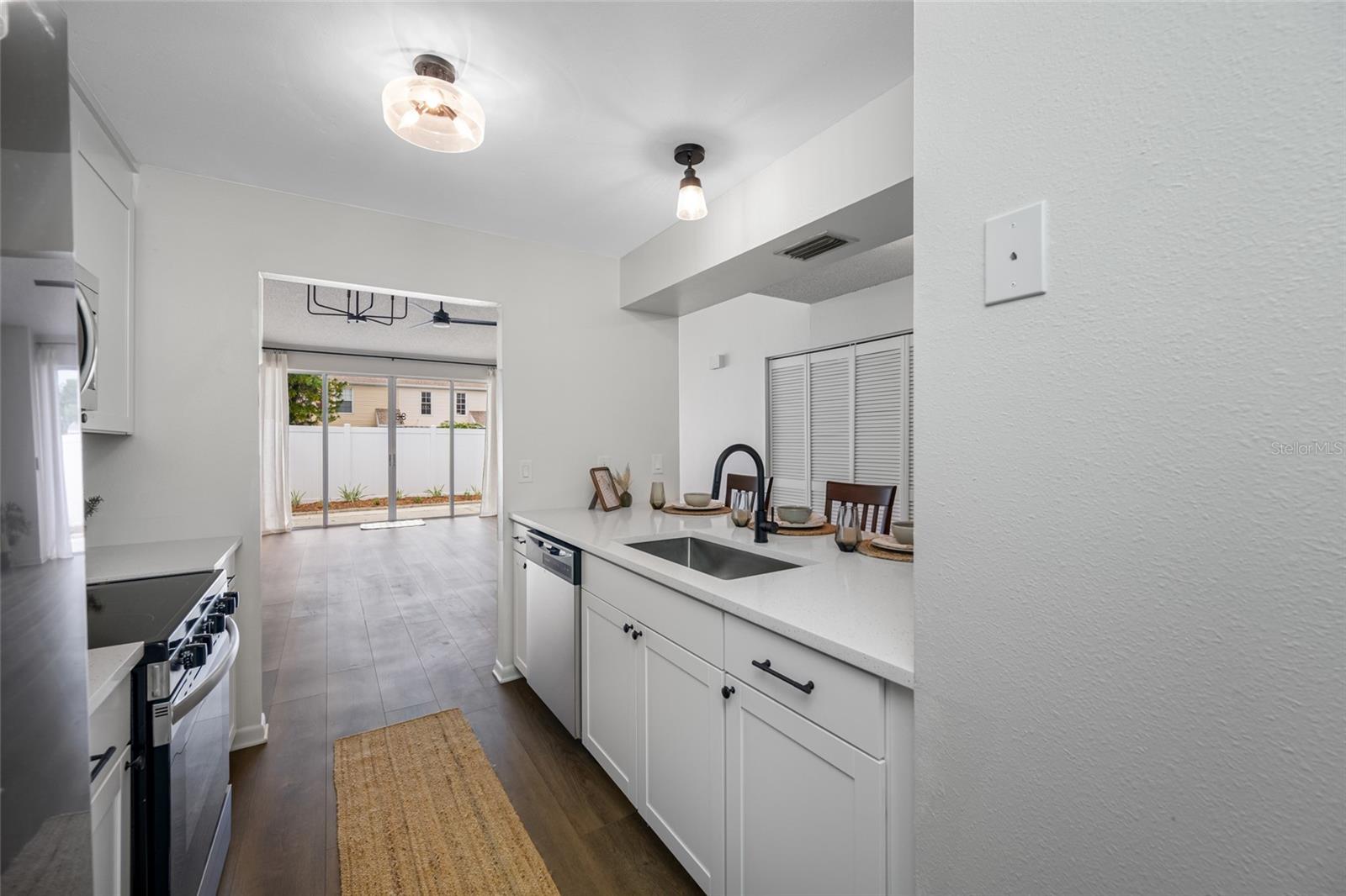 Kitchen open to Dining and Living Room offering generous natural light