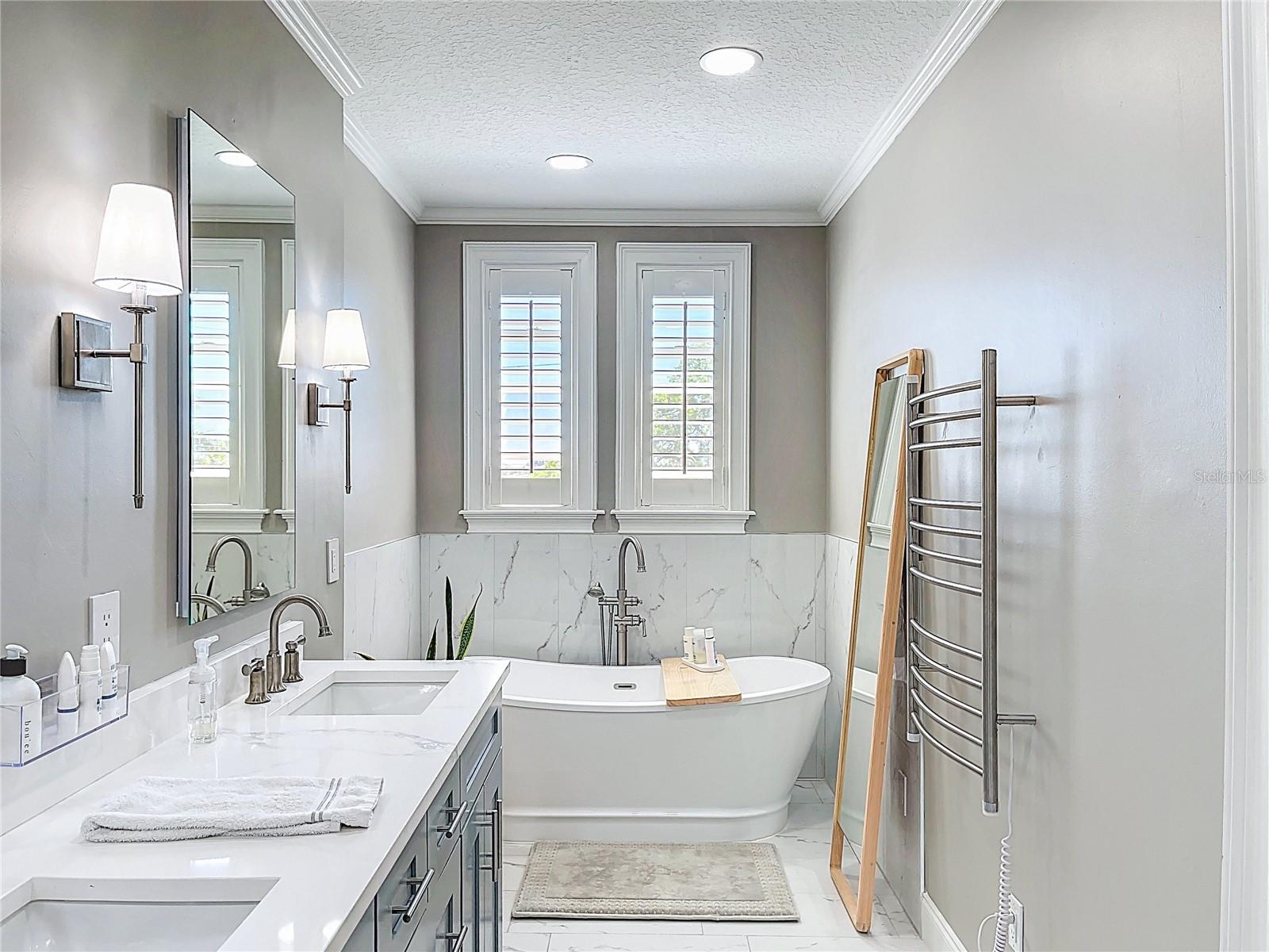 New primary, en-suite bathroom with soaking tub and towel heater.
