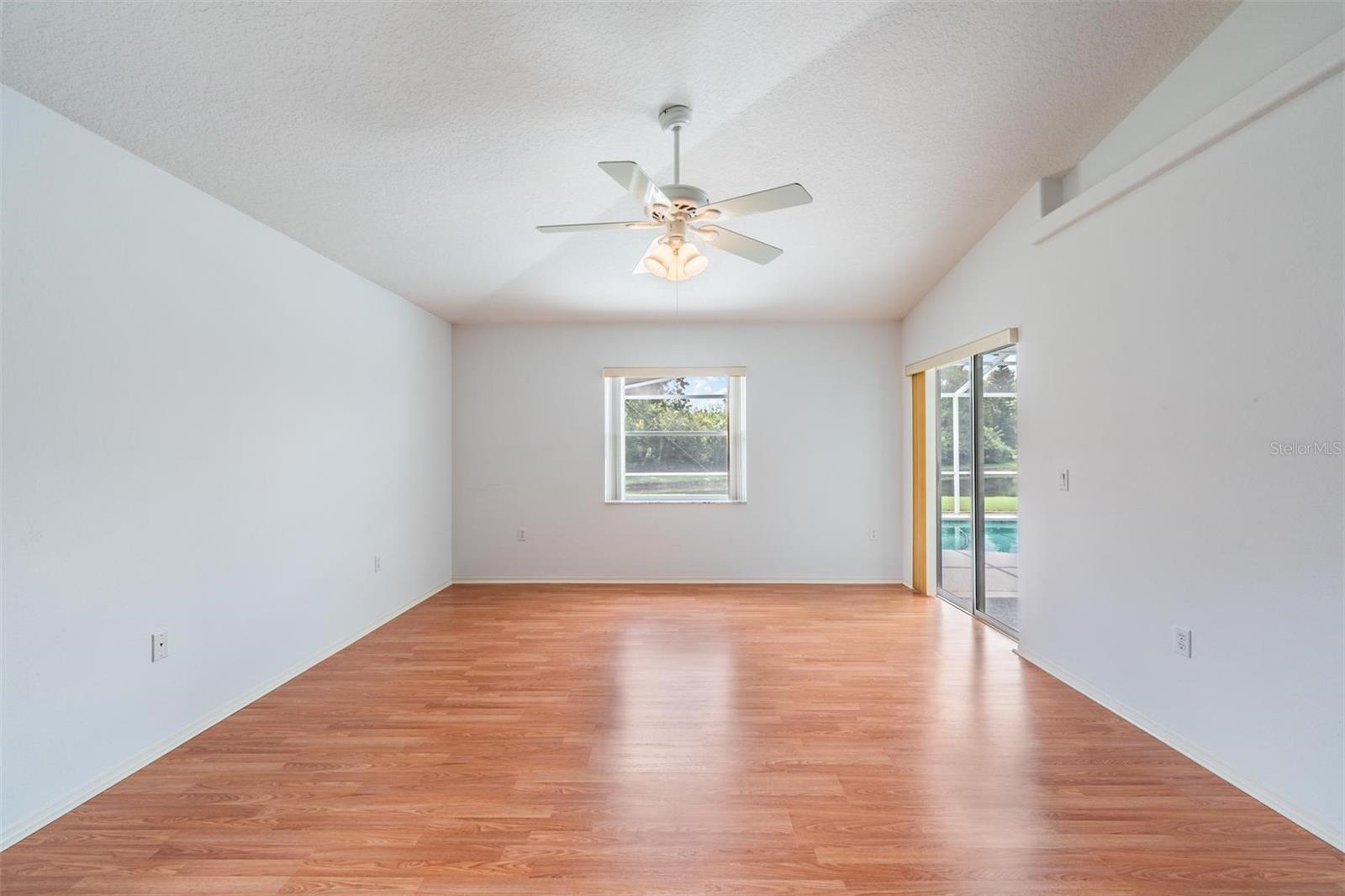 Master bedroom with sliding glass door for exterior entry