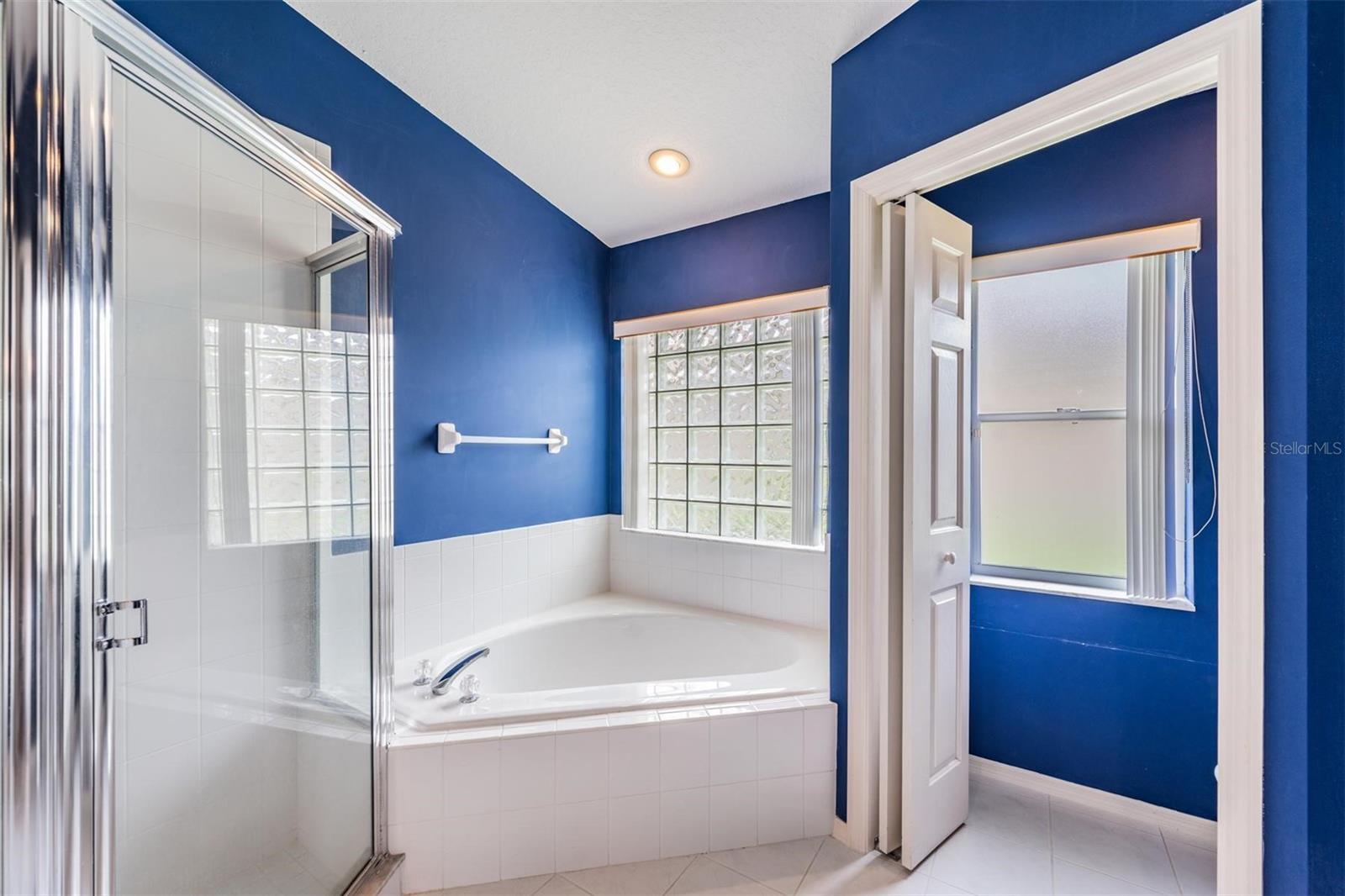 Corner soaking tub and water closet to the right