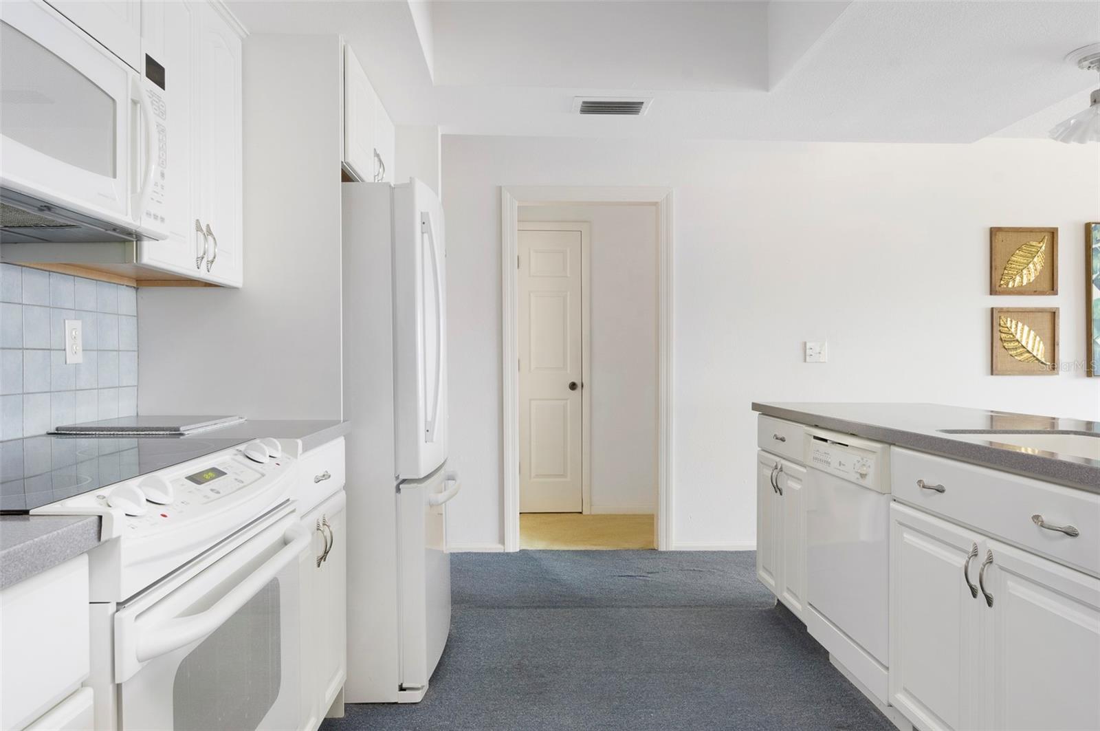 The kitchen features plenty of cabinets and soft-close drawers.