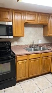 Full kitchen with sleek appliances and plenty of space for an island or chef cart