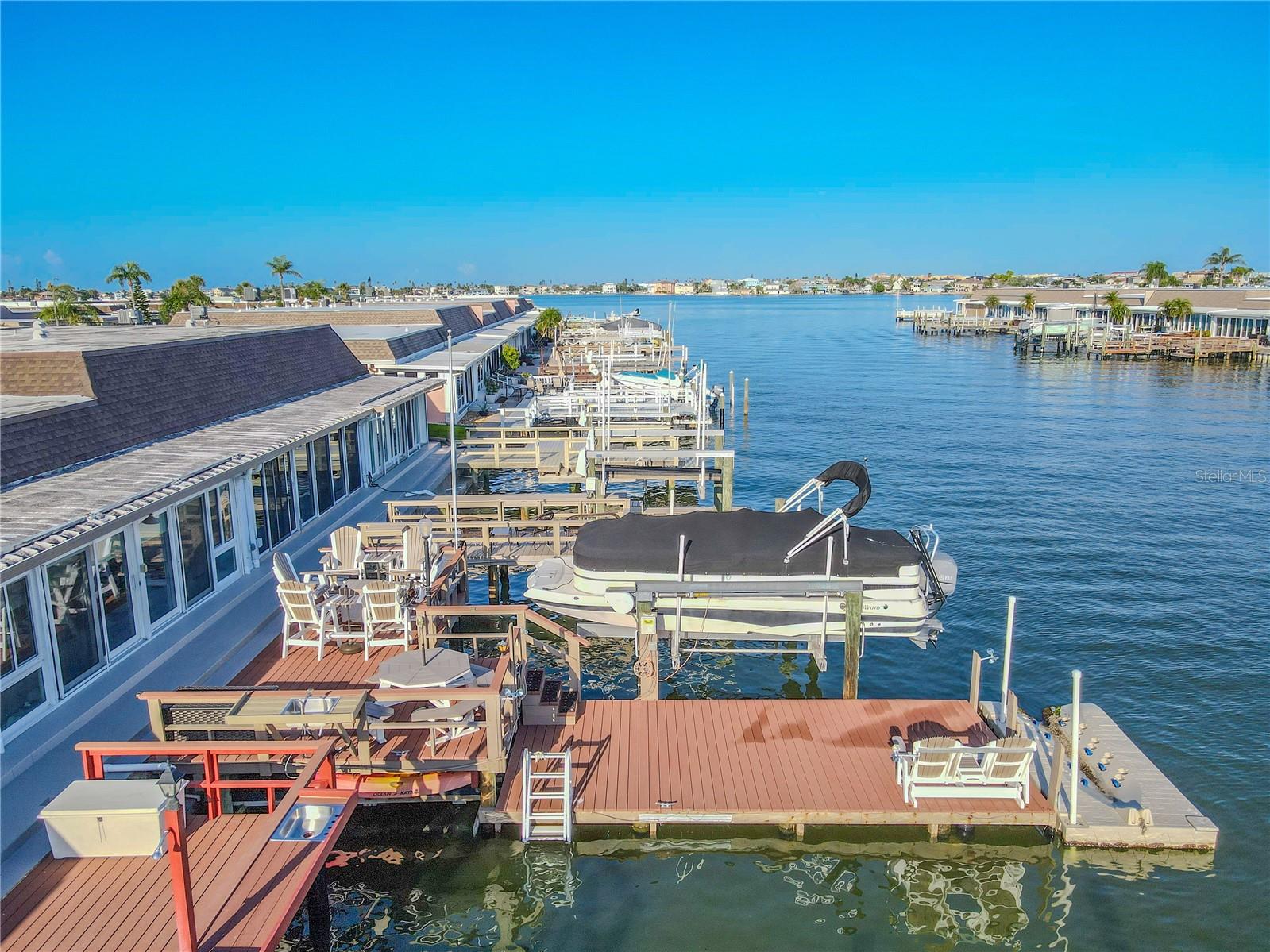 Boater’s paradise! This thoughtfully designed dock features a spacious Polywood upper deck perfect for relaxing or entertaining, while the lower dock offers easy water access and function. A 6,000 lb Deco boat lift with remote control makes launching a breeze, and the floating dock is jet ski–ready for added fun. Below the upper deck, a custom kayak rack holds two kayaks securely, and a large lockable deck box keeps life jackets, water toys, and gear organized. Enjoy the convenience of an outdoor counter with sink, plus flat roof tie-downs for added versatility and storage options. Whether you're a serious boater or a weekend water lover, this dock delivers comfort, storage, and adventure-ready amenities.