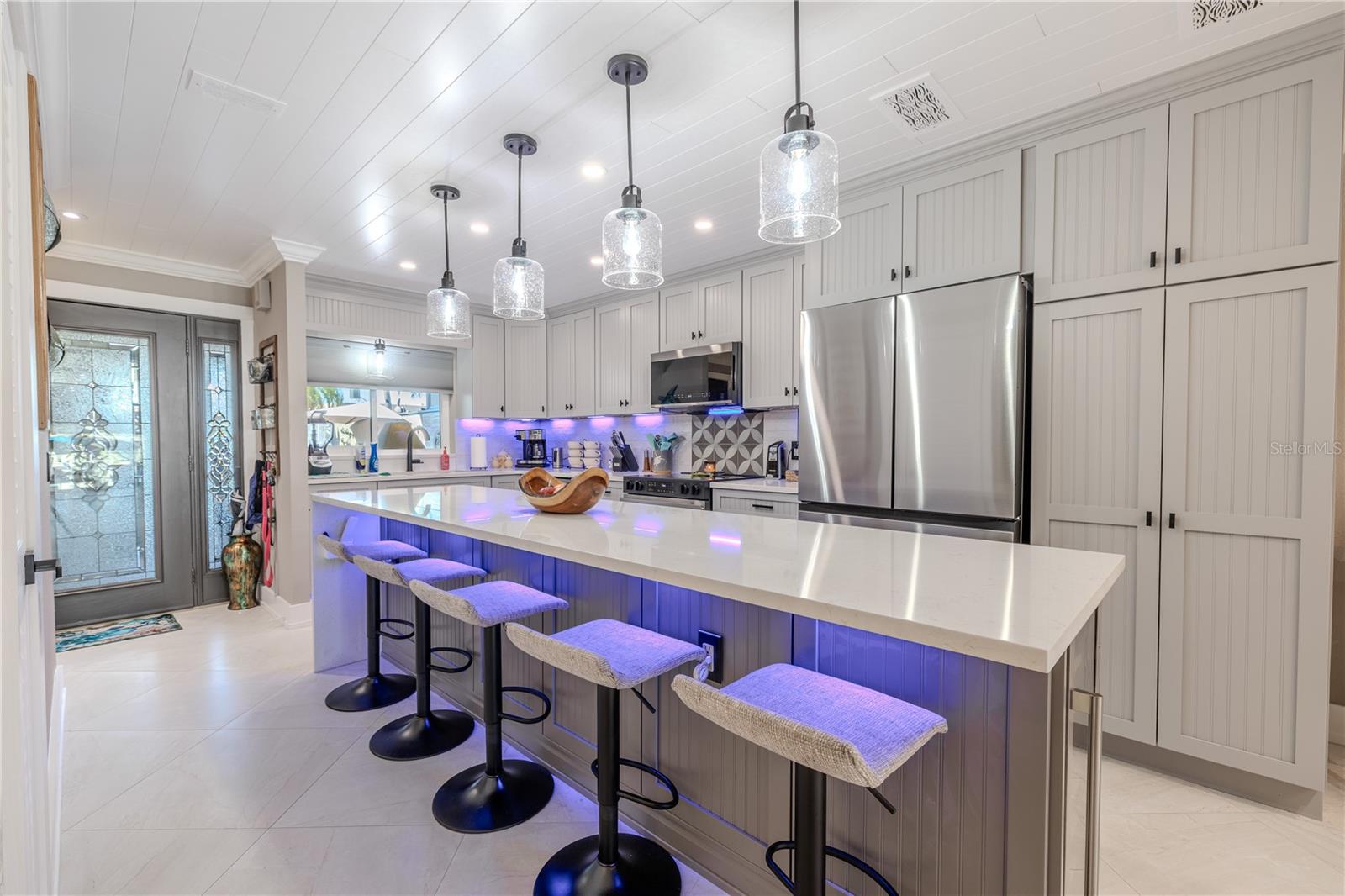 The kitchen features 5 high end glass pendant lights over island and sink along with 6 LED can lights on a dimmer control. The Under cabinet LED lighting can be adjusted to any color desired.