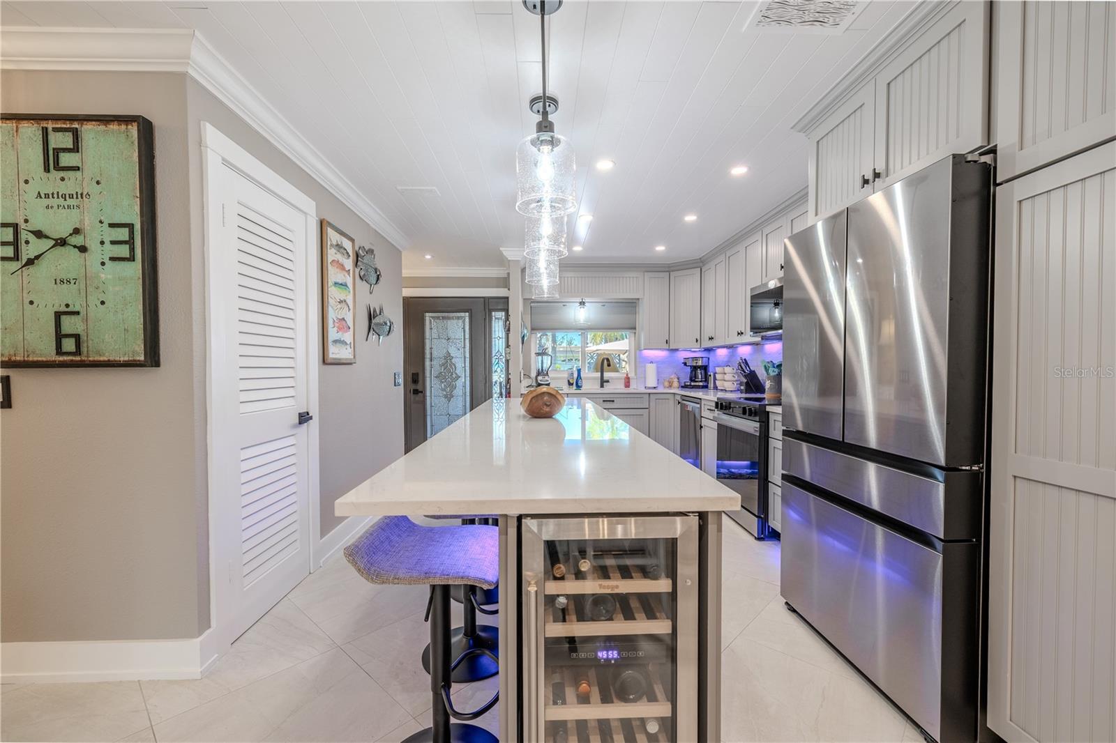 The kitchen island houses a wine fridge holding 20 bottles at 2 different temperatures.