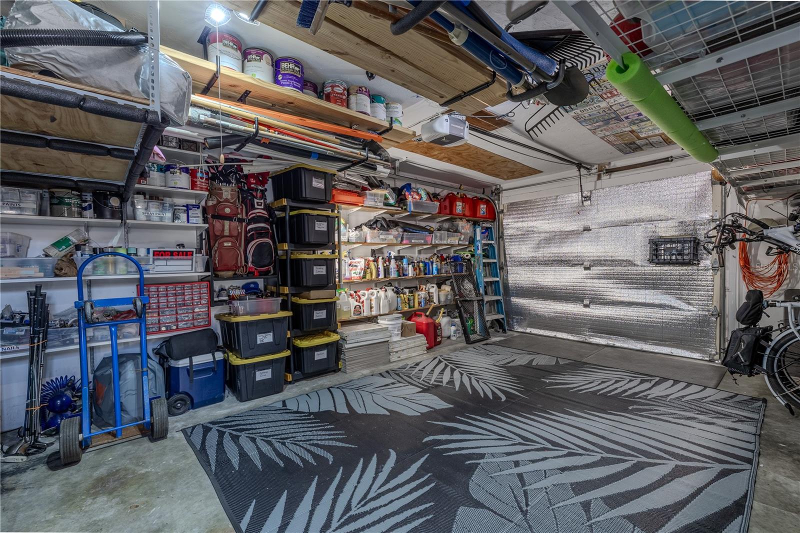 The oversized 1½-car garage is packed with practical upgrades, including three overhead loft racks, extensive wall shelving, and an insulated garage door for year-round comfort. You'll also find a utility sink with hot and cold water, new hot water tank, newer washer/dryer, and a newer water softener system. Bonus features include a TV, refrigerator, and built-in workbench—making this space ideal for projects, hobbies, or just staying organized.