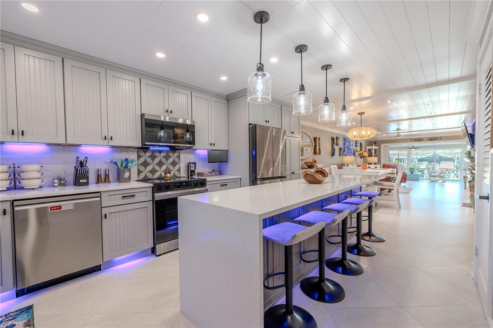 The kitchen features all new high end custom kitchen cabinets with soft close hinges.  5 pull out drawers in the pantry, lazy susan, 124 inch island that seats 6, with new 1 ¼” quartz countertops.