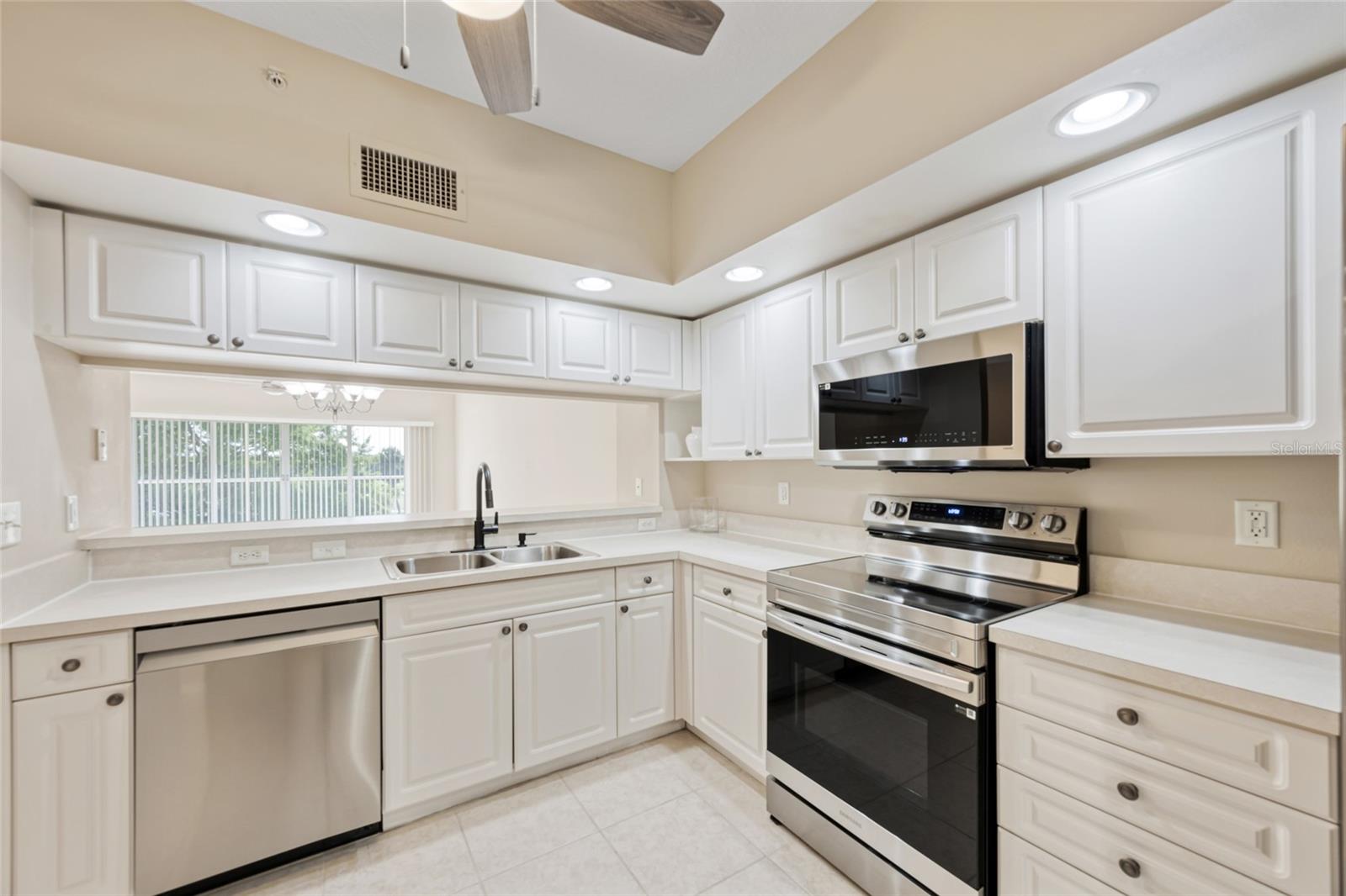 Brand New Samsung appliances in kitchen with space for a breakfast nook.