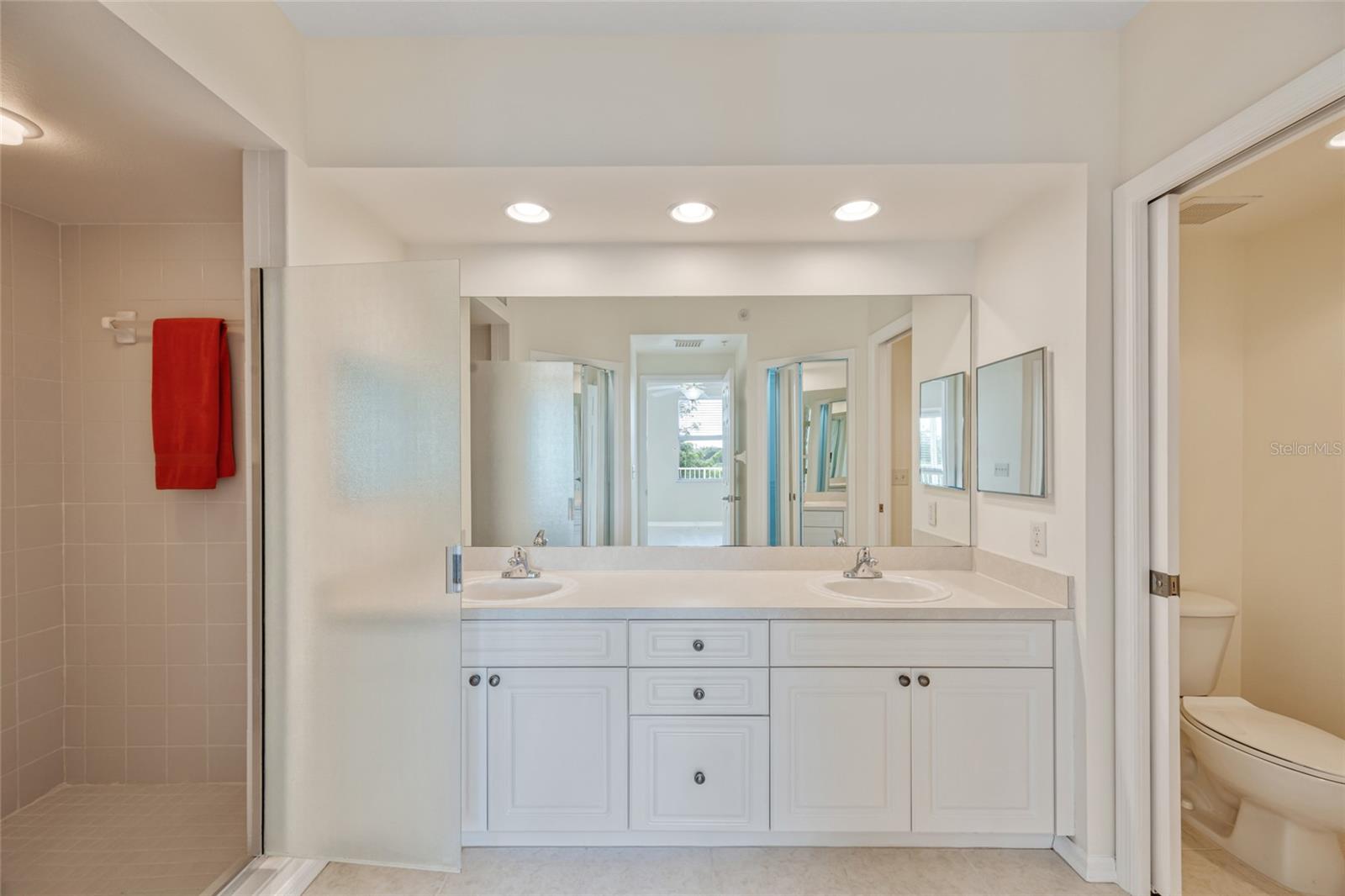 Primary En Suite with dual sinks, private water closet with new toilet and large walk in shower.