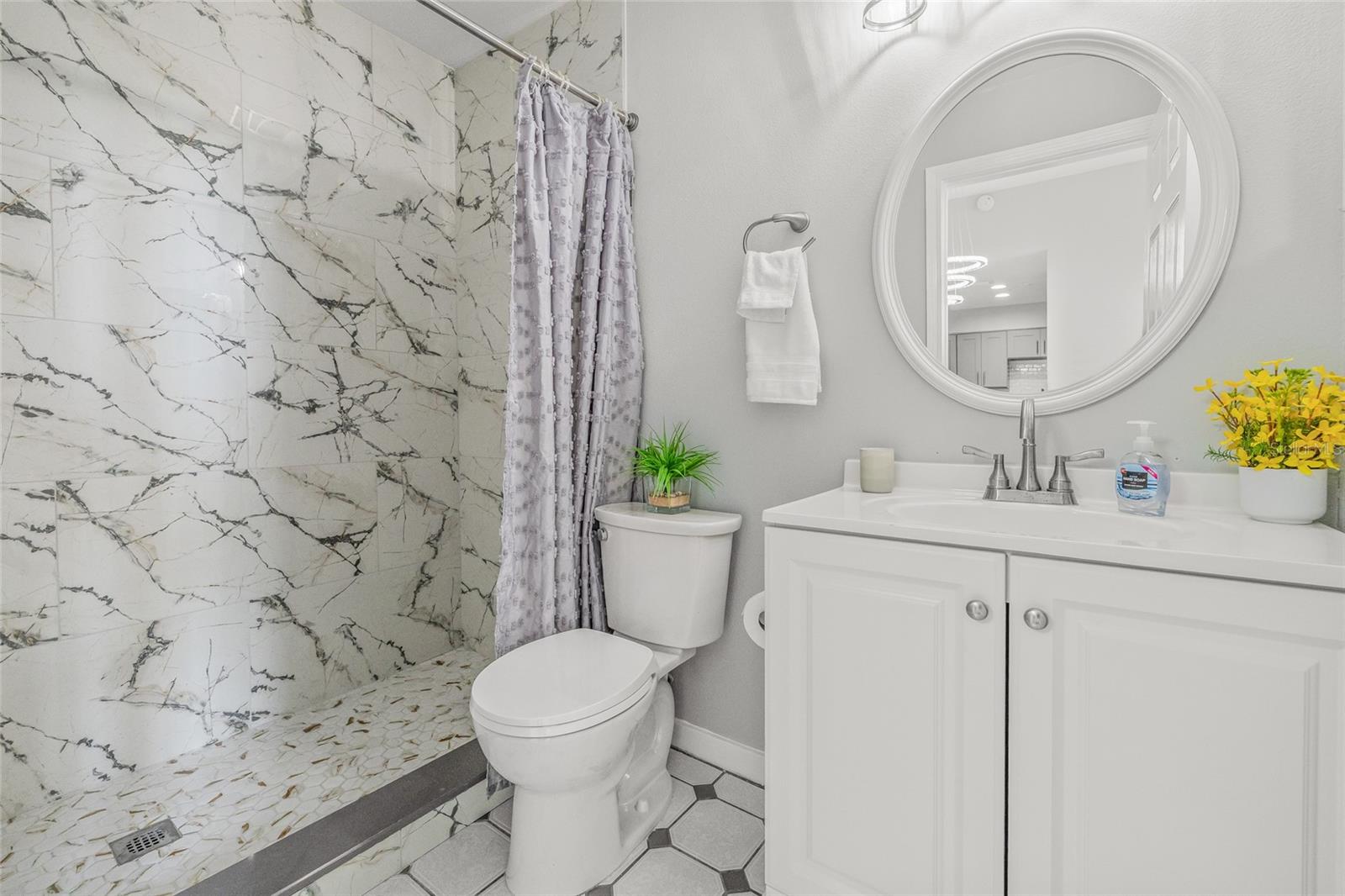 Guest Bathroom with Newly Tiled Step-In Shower and New Toilet