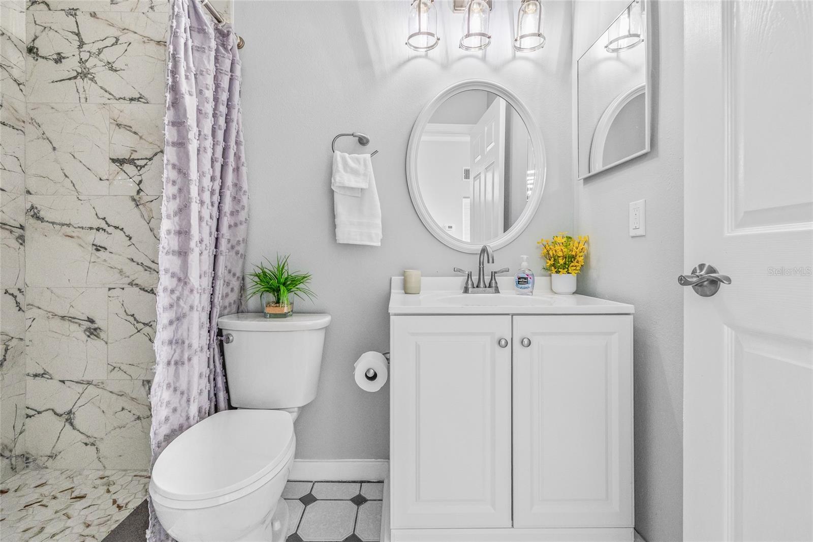 There is a beautiful new vanity, new mirror and new light fixture