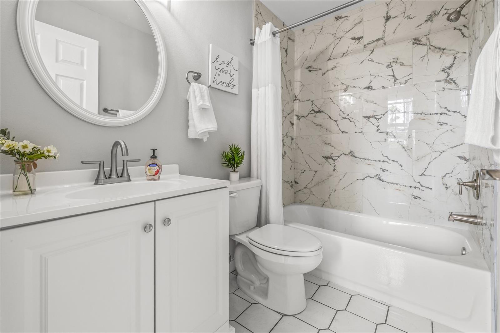 The Master Bathroom  has a beautifully tiled tub/shower combo