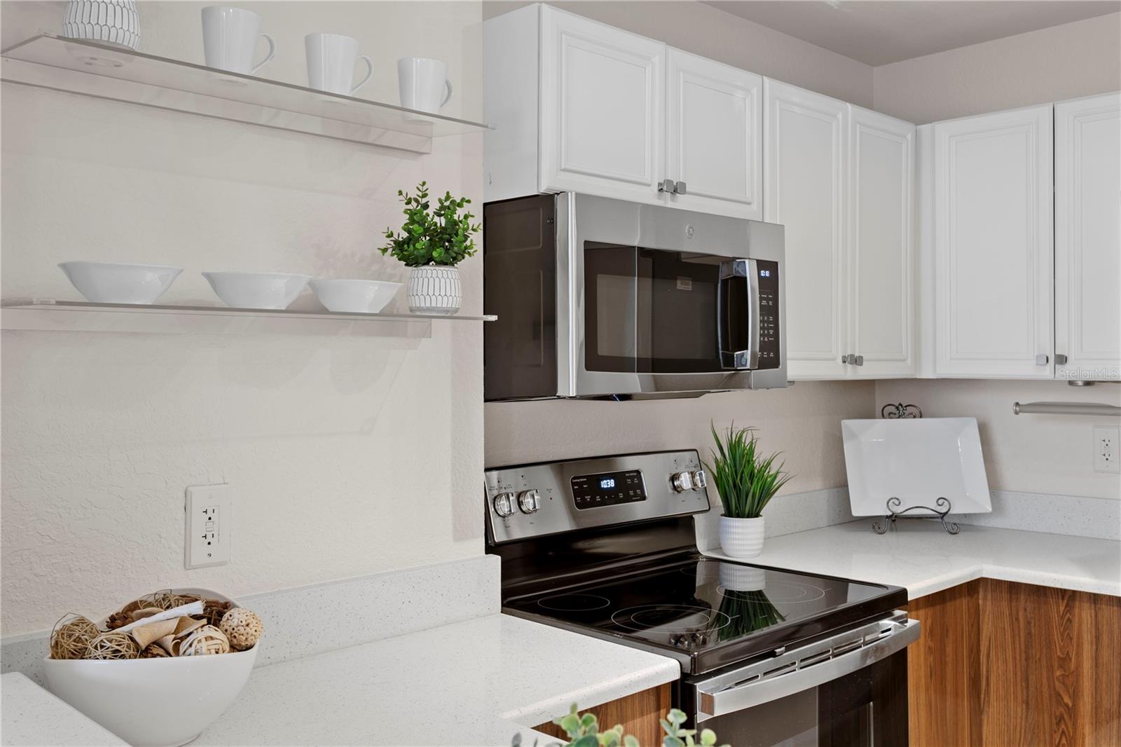 Open floating shelves provide a stylish and functional space to showcase your favorite dishware or curated kitchen décor.