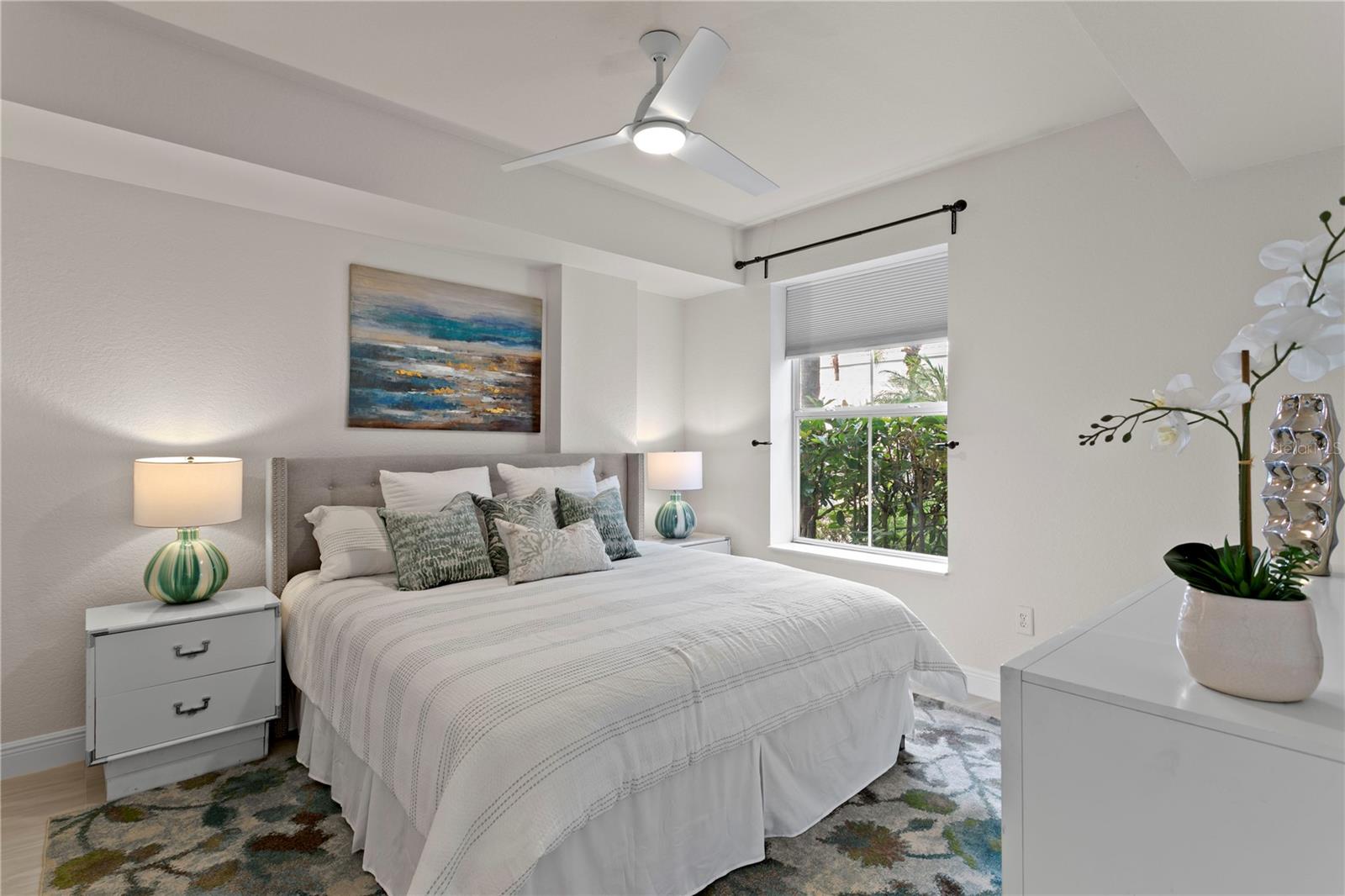 The primary bedroom overlooks the serene courtyard, offering a peaceful retreat with calming views just beyond your windows.
