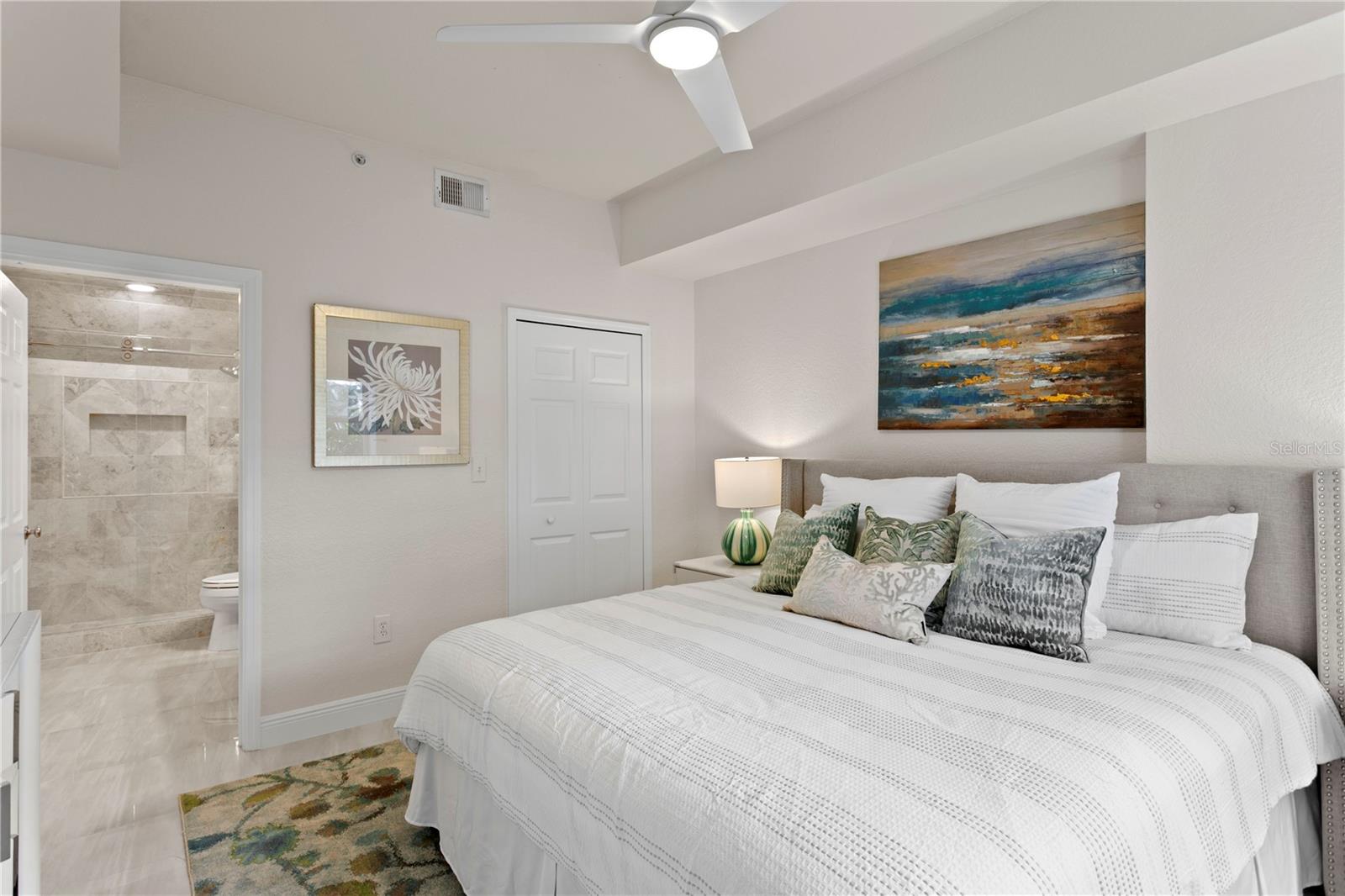 The primary bedroom offers a walk-in closet, direct bath access, and peaceful courtyard views