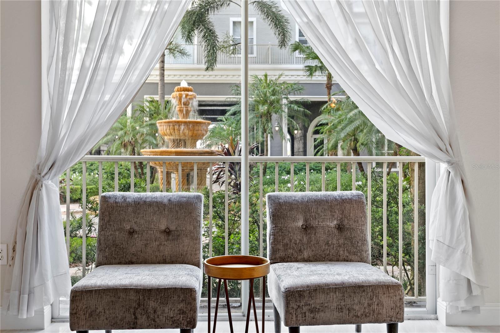 This beautifully refreshed residence overlooks a serene, landscaped courtyard complete with tranquil waterfalls and magical twinkle lights that come alive in the evening.