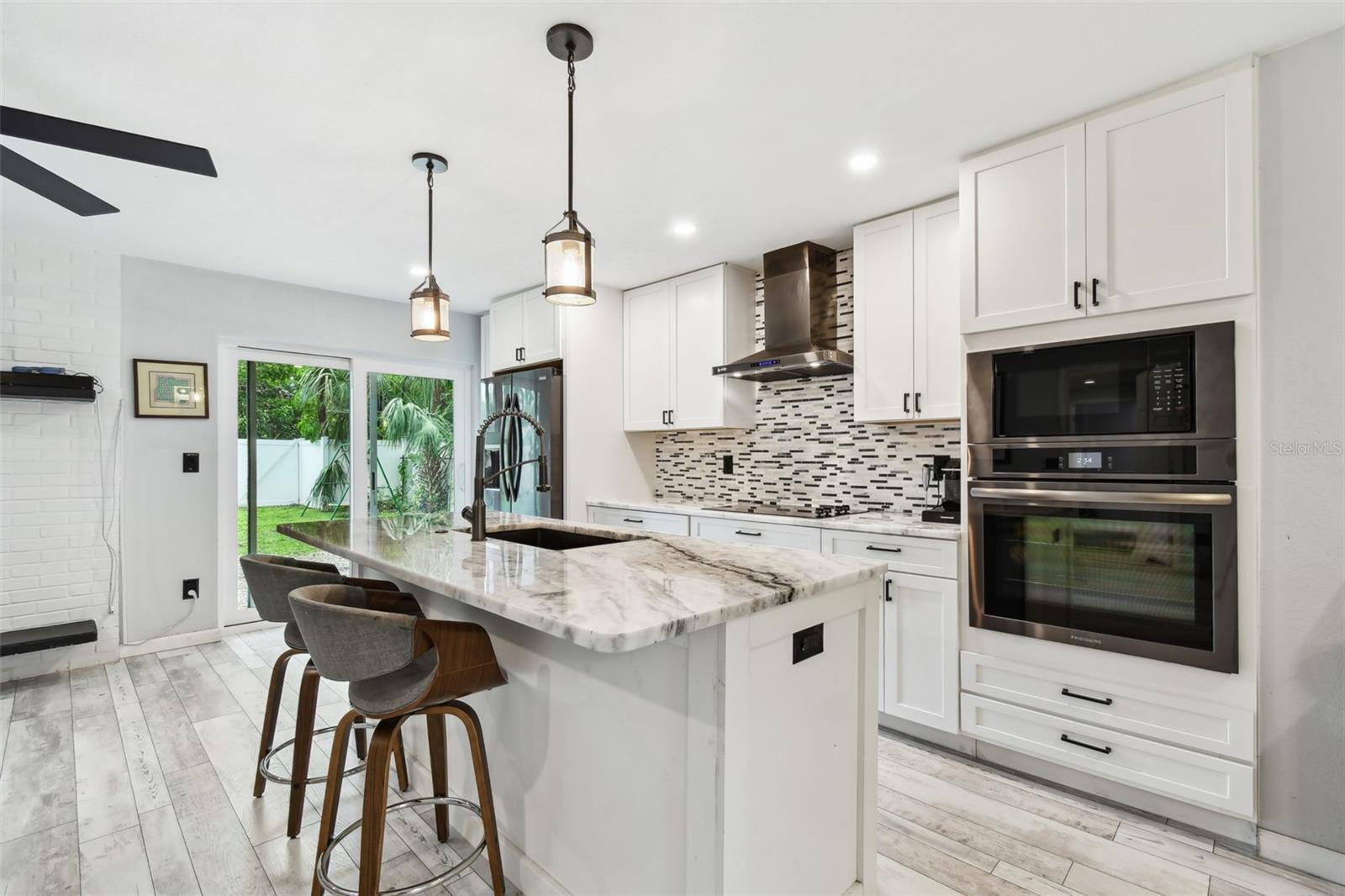 Granite countertops, built-in pantry, center island and built-in oven and cooktop.