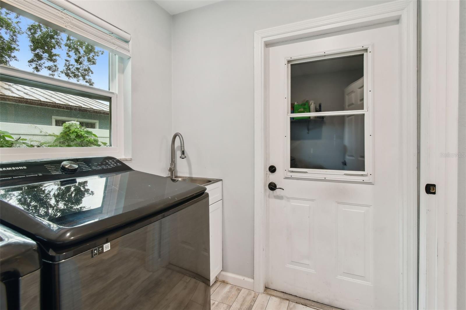 Inside laundry room just inside the garage door, comes complete with washer and dryer.
