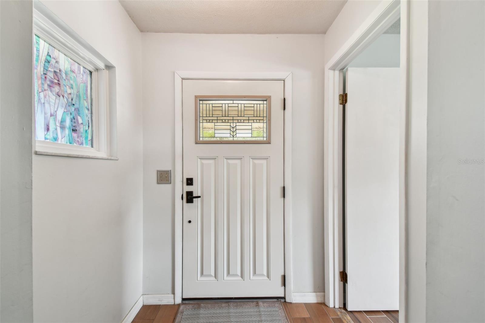 Beautiful stained glass in entryway and entrance to Primary Bedroom