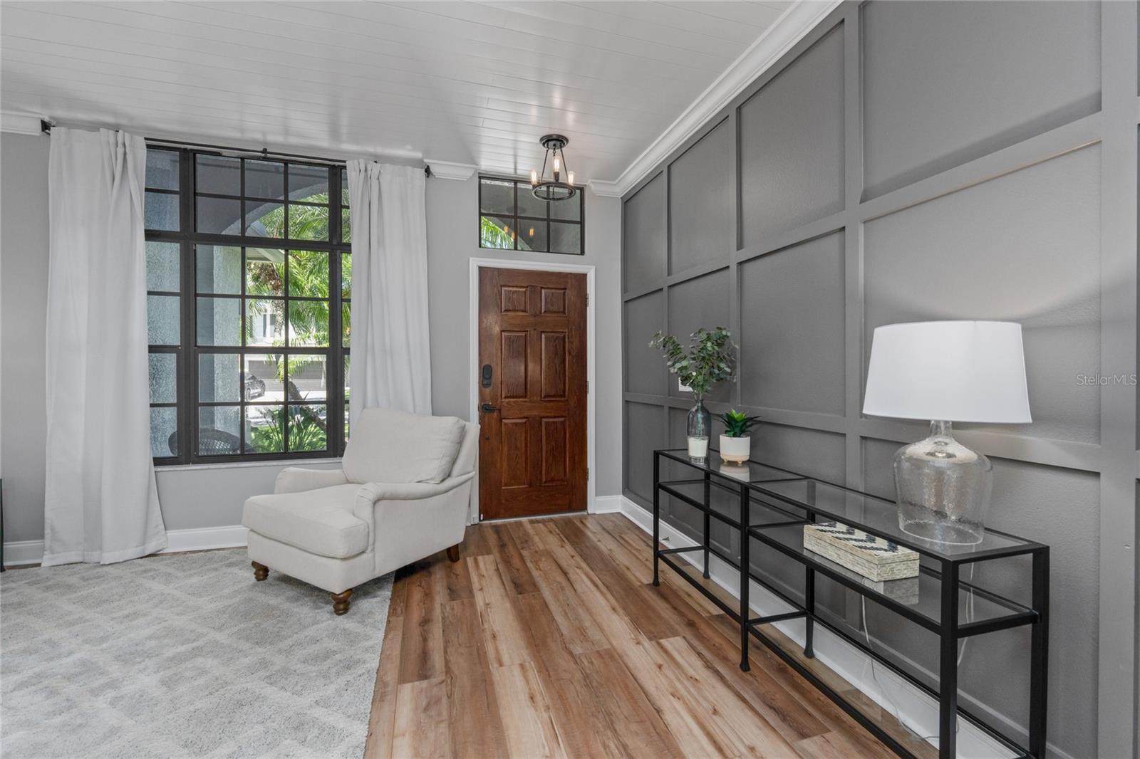 Foyer area with decorative wood paneling