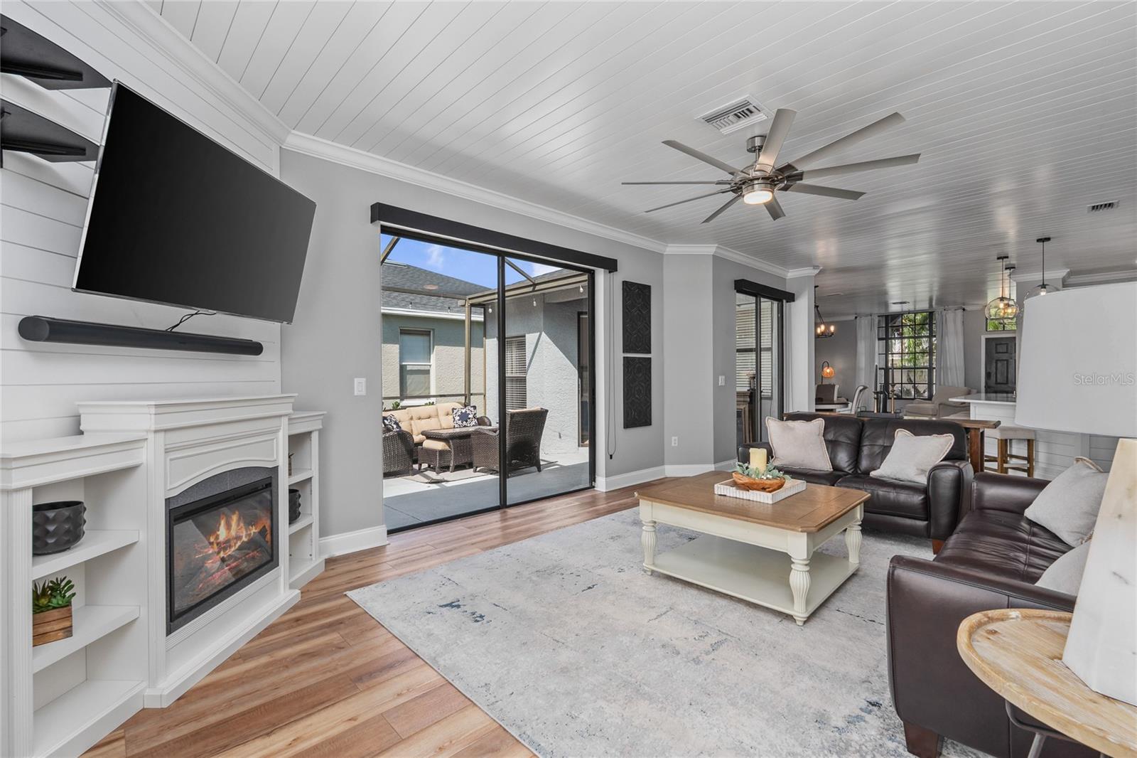 Family Room with Fireplace, custom blinds and shiplap on ceilings