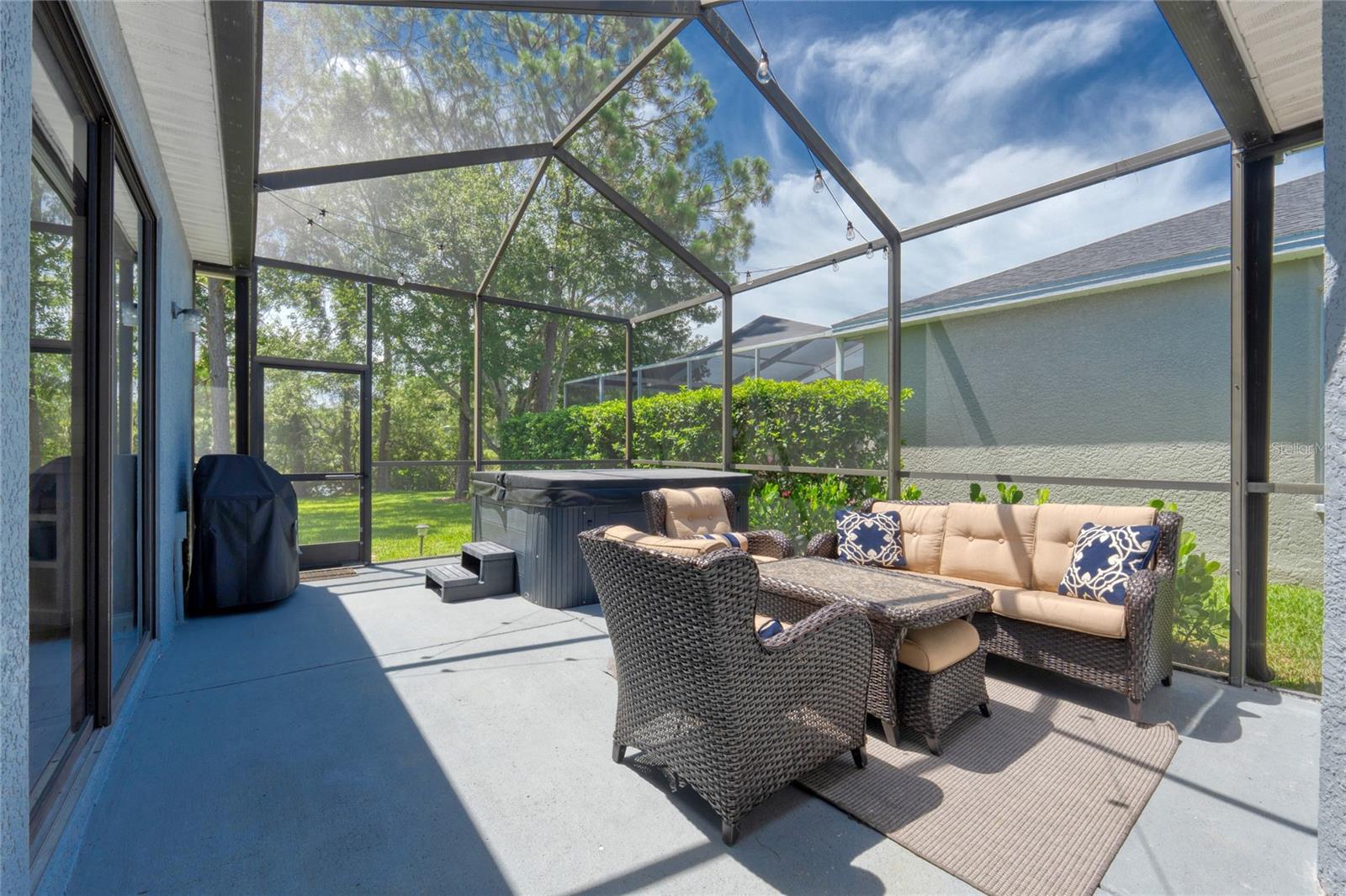 Screened in Lanai with Hot Tub that is included in the sale