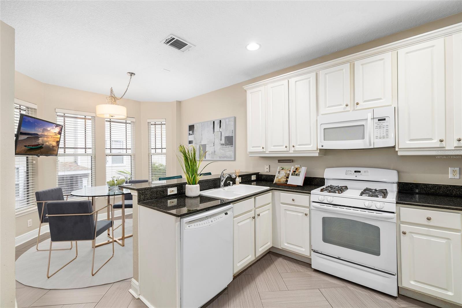 Virtually Staged Light and Bright Kitchen with Breakfast Bar and Dining Nook