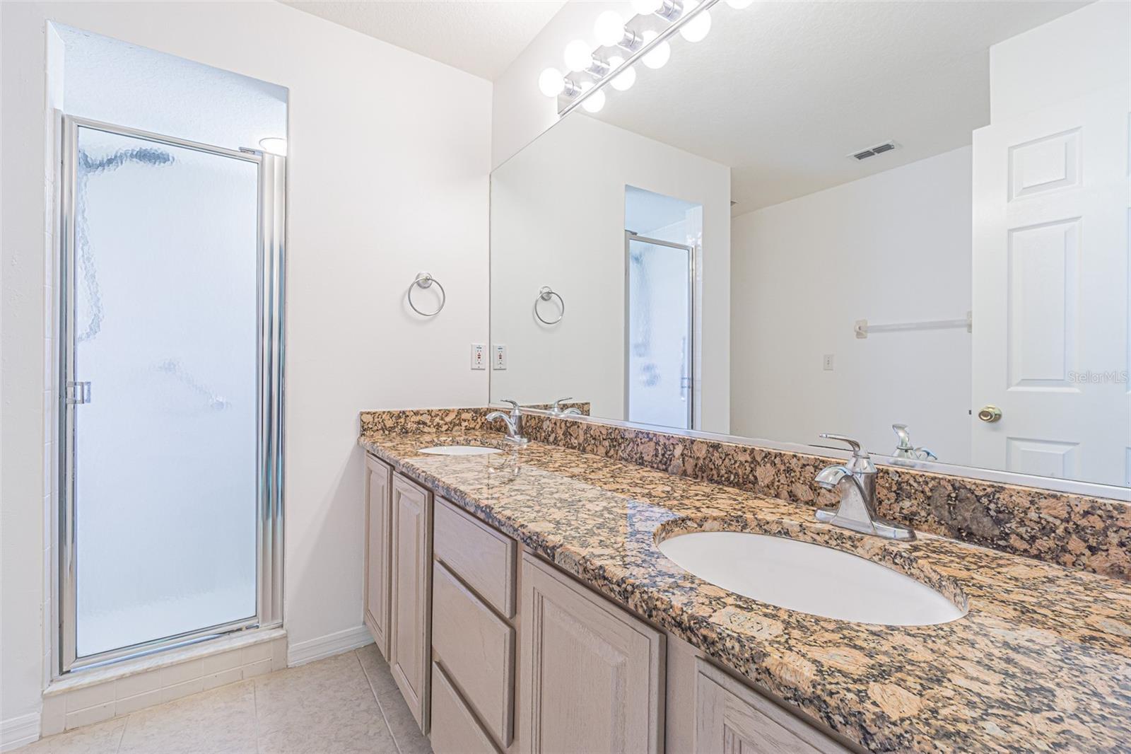 Granite counters with dual sinks in primary bath