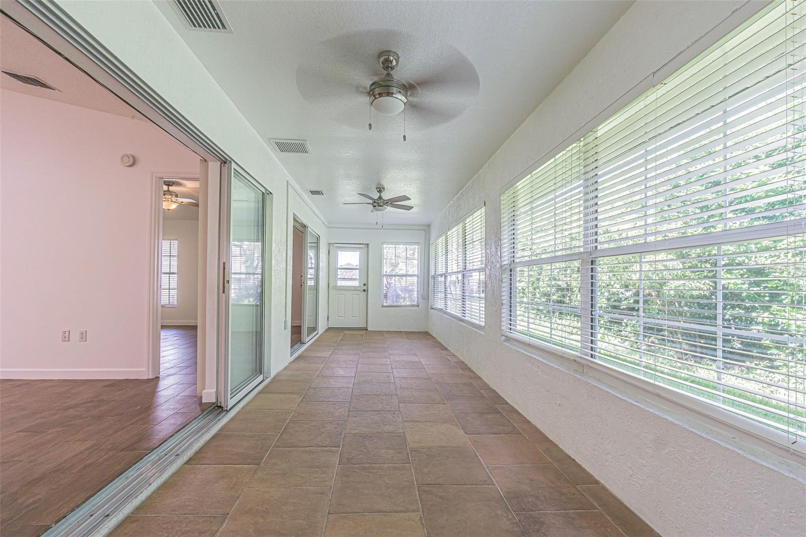 Spacious Enclosed Florida room with AC ducts and glass windows