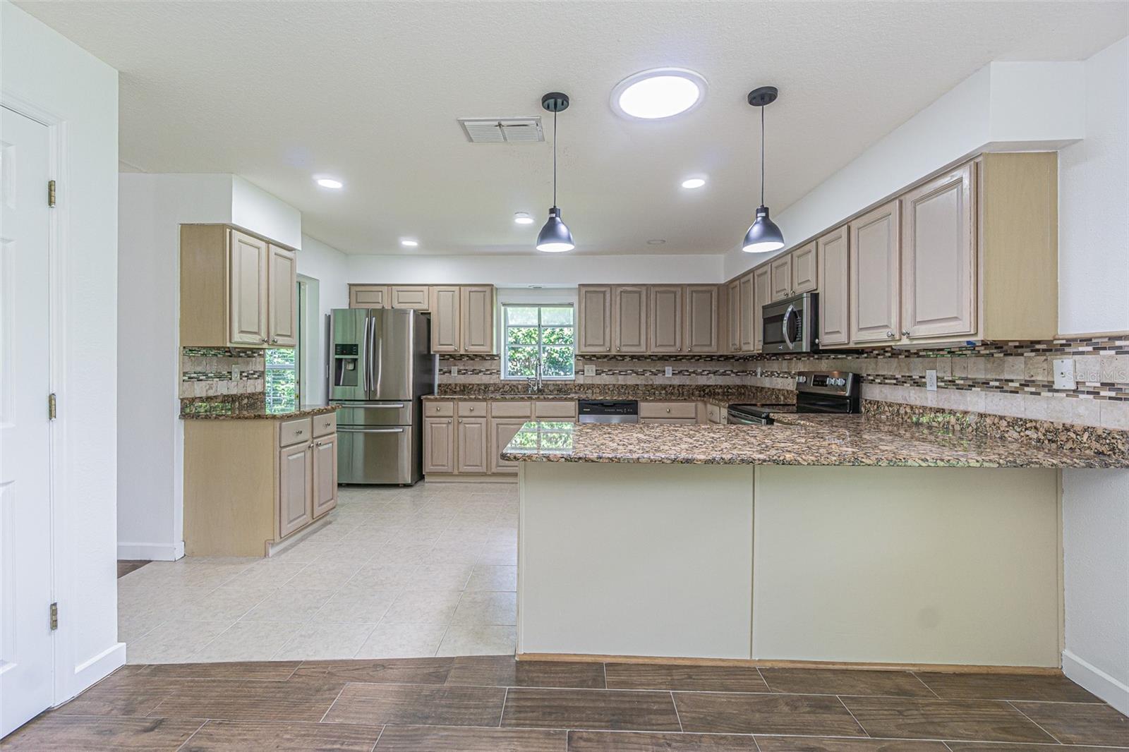 Breakfast bar is OPEN to dining area in kitchen